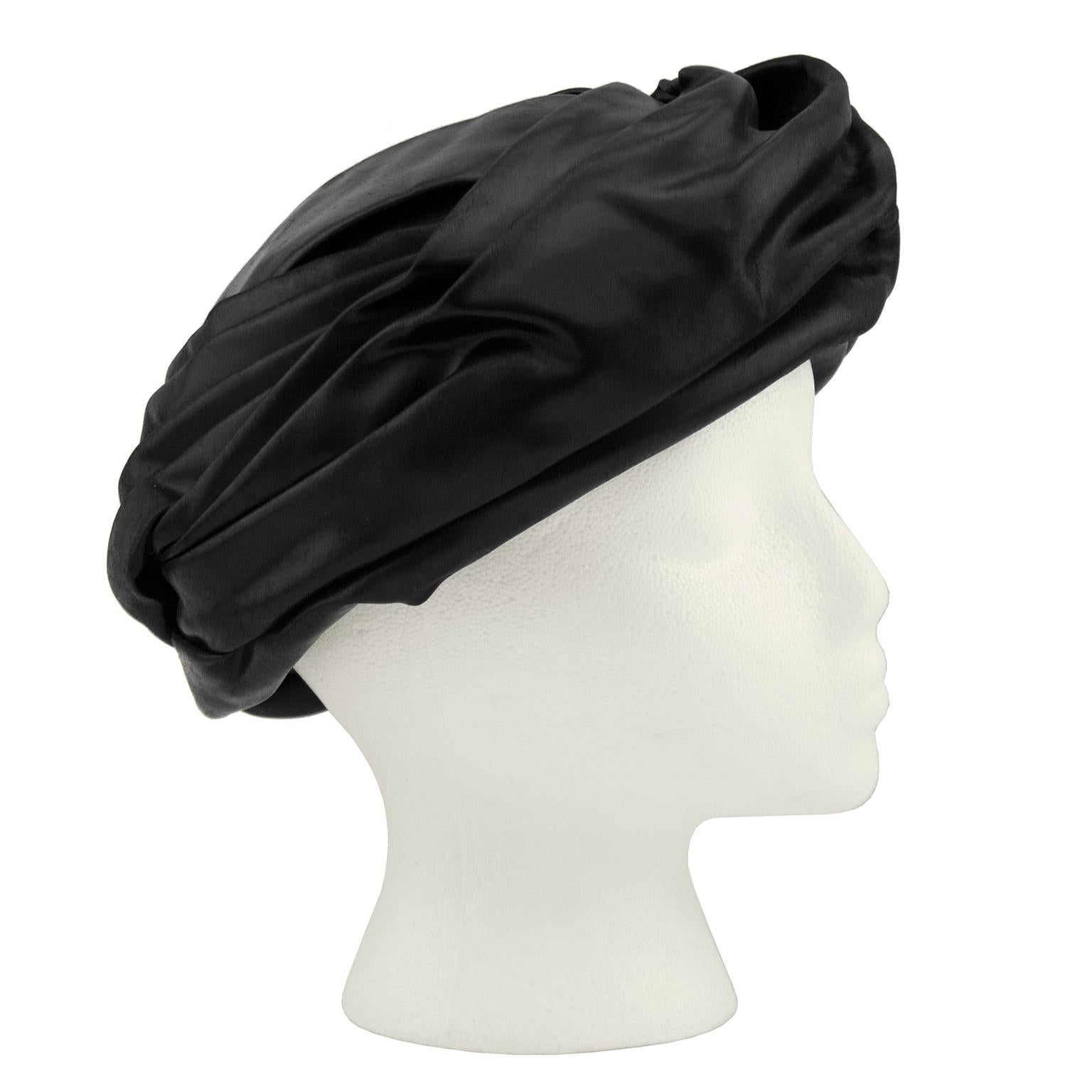 Constructed from waxed cotton, this 1950s Christian Dior black turban is as effortless as it is chic. Labeled Christian Dior Chapeaux Paris- New York, it is in perfect condition. 