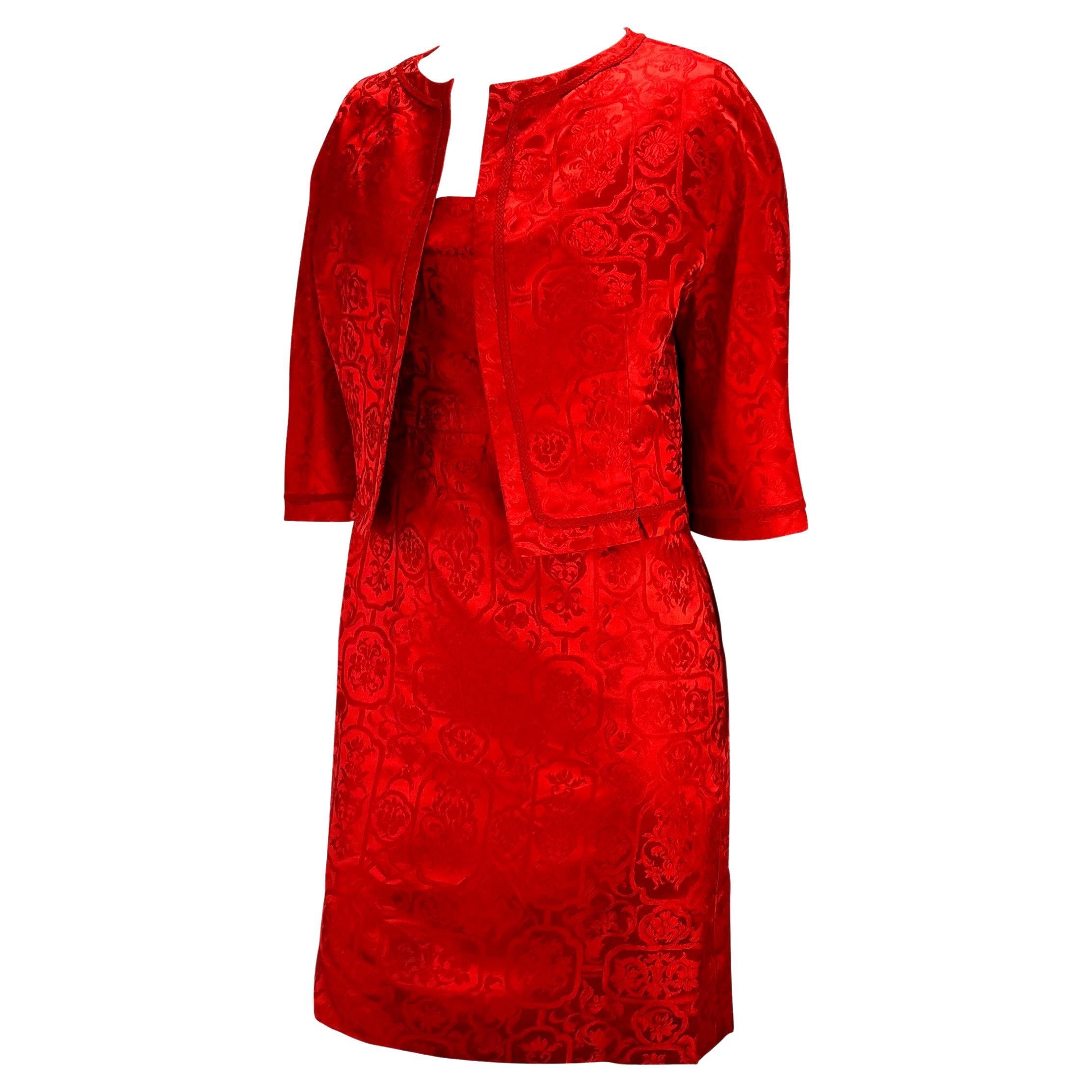 TheRealList presents: a stunning red satin Christian Dior Boutique dress set, designed by Christian Dior. From the 1950s, this beautiful set is constructed of bright red satin with a floral brocade pattern. The a-line dress features a square