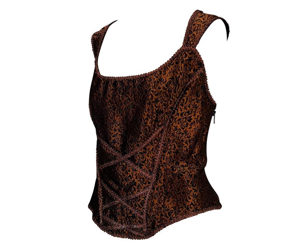 Presenting a copper colored metallic Christian Dior Boutique bustier bodice top, designed by, the brand's founder and namesake, Christian Dior. This piece is constructed of a baroque print and is finished with a detailed embroidery trim. The front