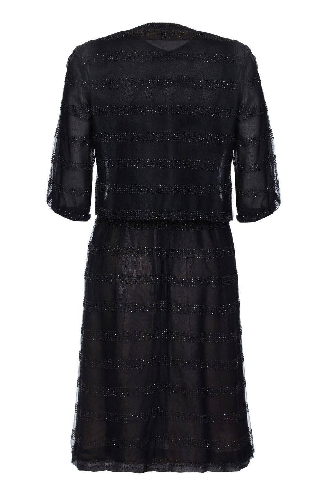 This captivating mid to late 1950s Christian Dior dress with matching jacket is of exceptional quality and in superb vintage condition. The dress has a Harrods of London label in addition to the Dior Modelé Original label sewn into the underlay. The