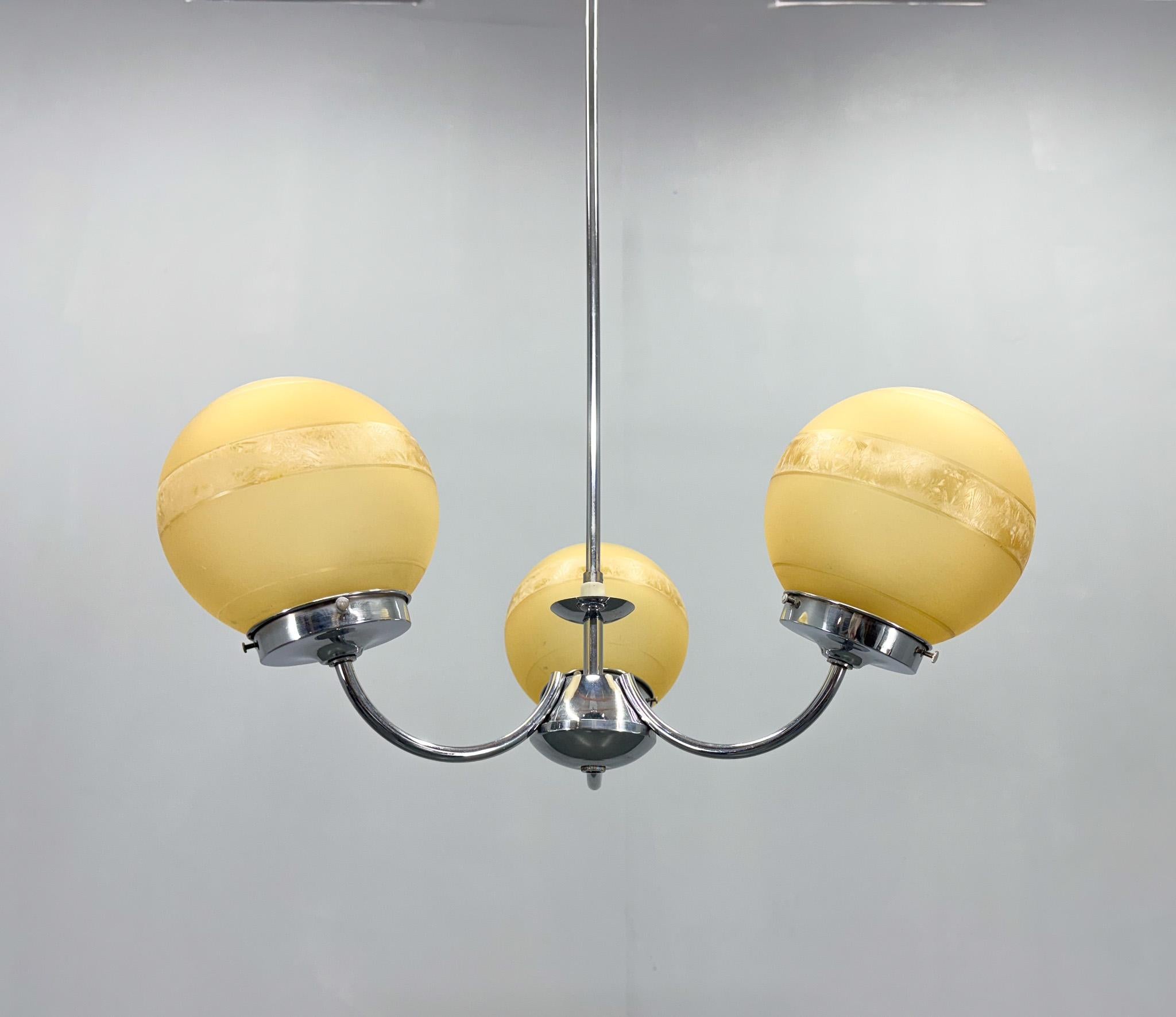 Mid century chrome three-arm chandelier with shades made of interesting sandblasted glass. 
Bulbs: 3 x E27(E26). US wiring compatible.