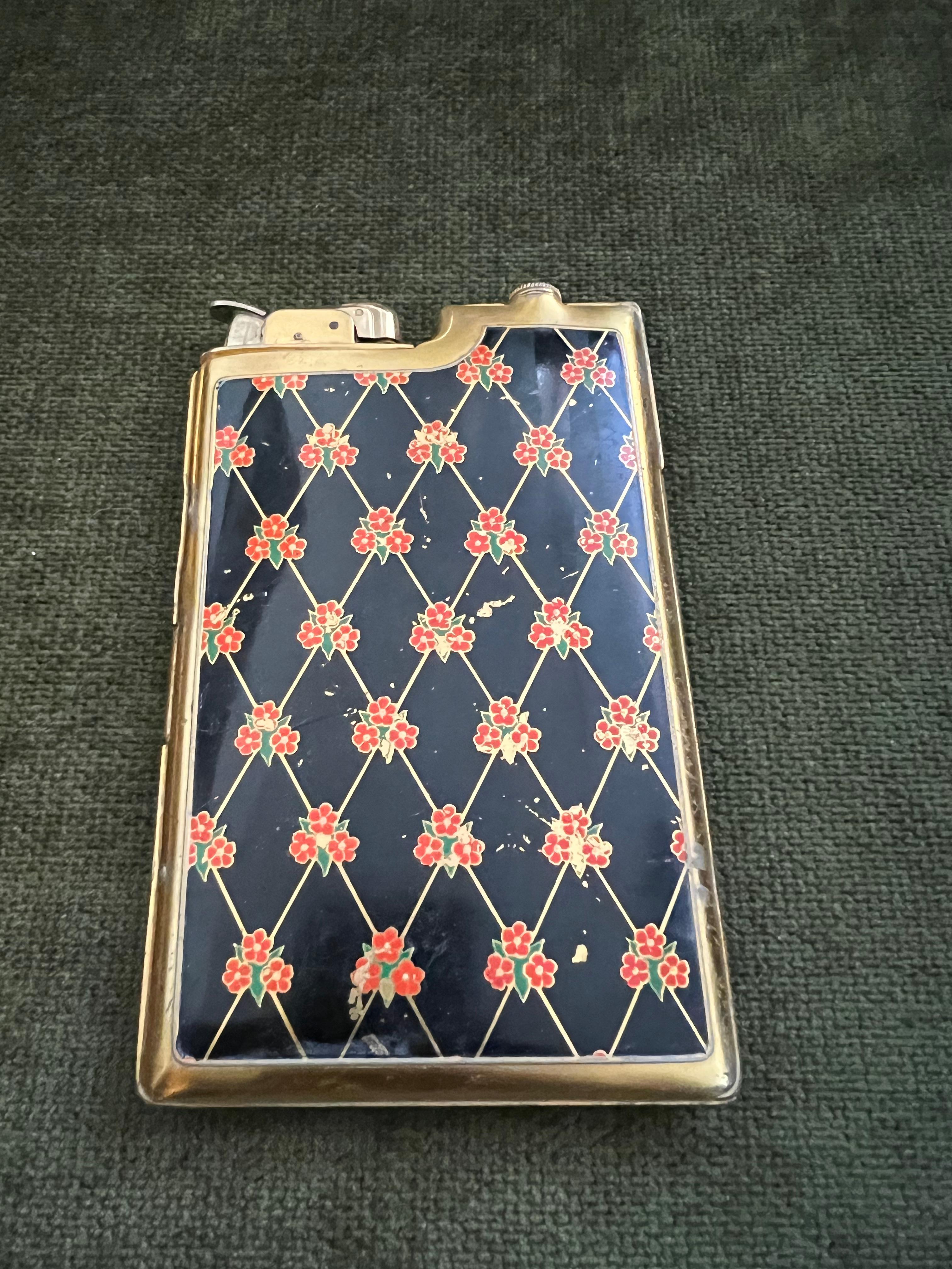 Evans Vintage Ladies Cigarette and Lighter case.
Black enamel with colorful inlay. 
The enamel is in good condition but has some scratches as you might expert from a case dating back to the 1950s. 
Very rare to find a case such as this. 
The gold