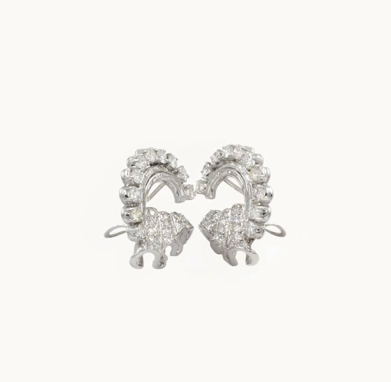 Vintage diamond circular ribbon and platinum earrings from circa 1950s.  These gorgeous earrings feature a mix of round brilliant cut diamonds and baguette cut diamonds.  The earrings have 8 carats in total diamond weight with the diamonds being H-I