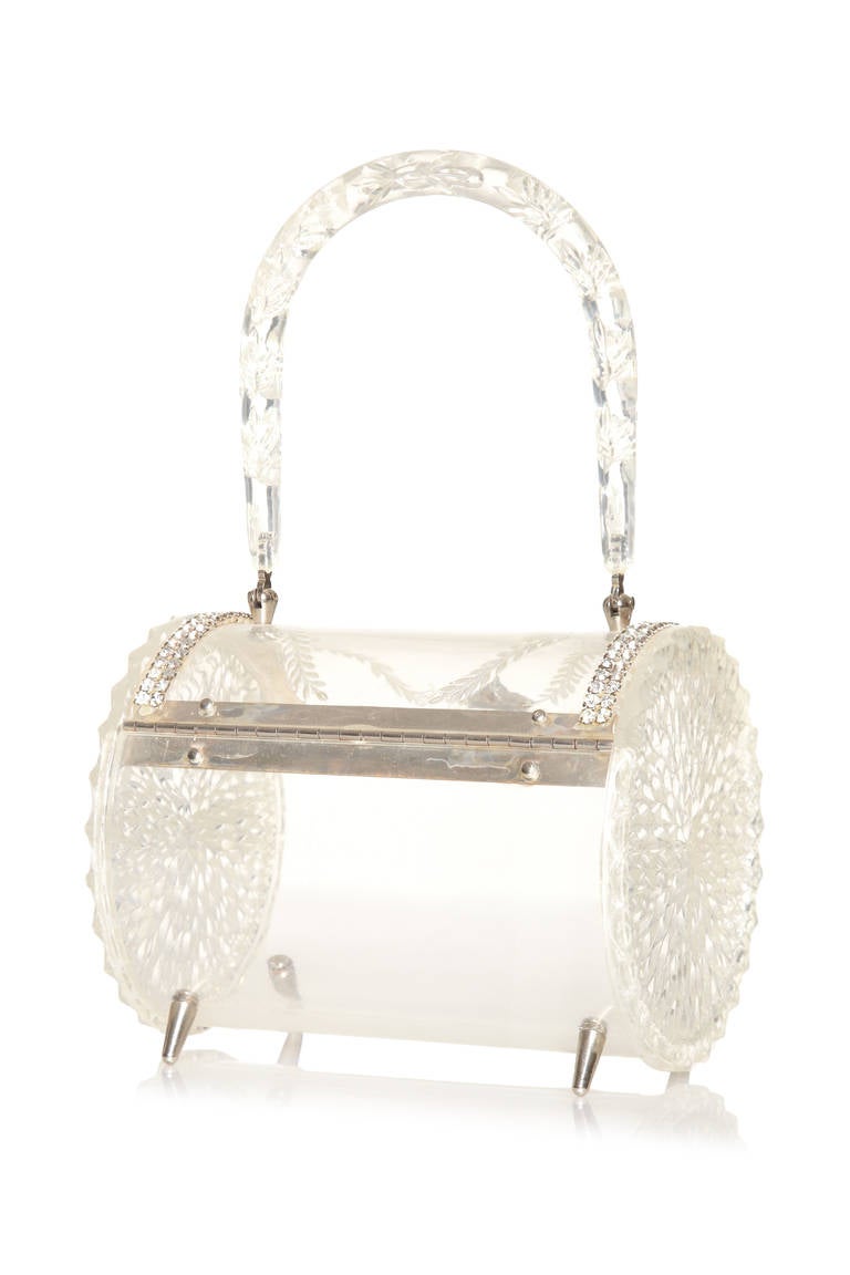 Incredible and rare 1950s clear carved lucite drum and rhinestone set bag.  Hinged lid closes with the 3-ball clasp.  Some of the most spectacular and expensive rhinestone examples were made in Miami, the home of the 