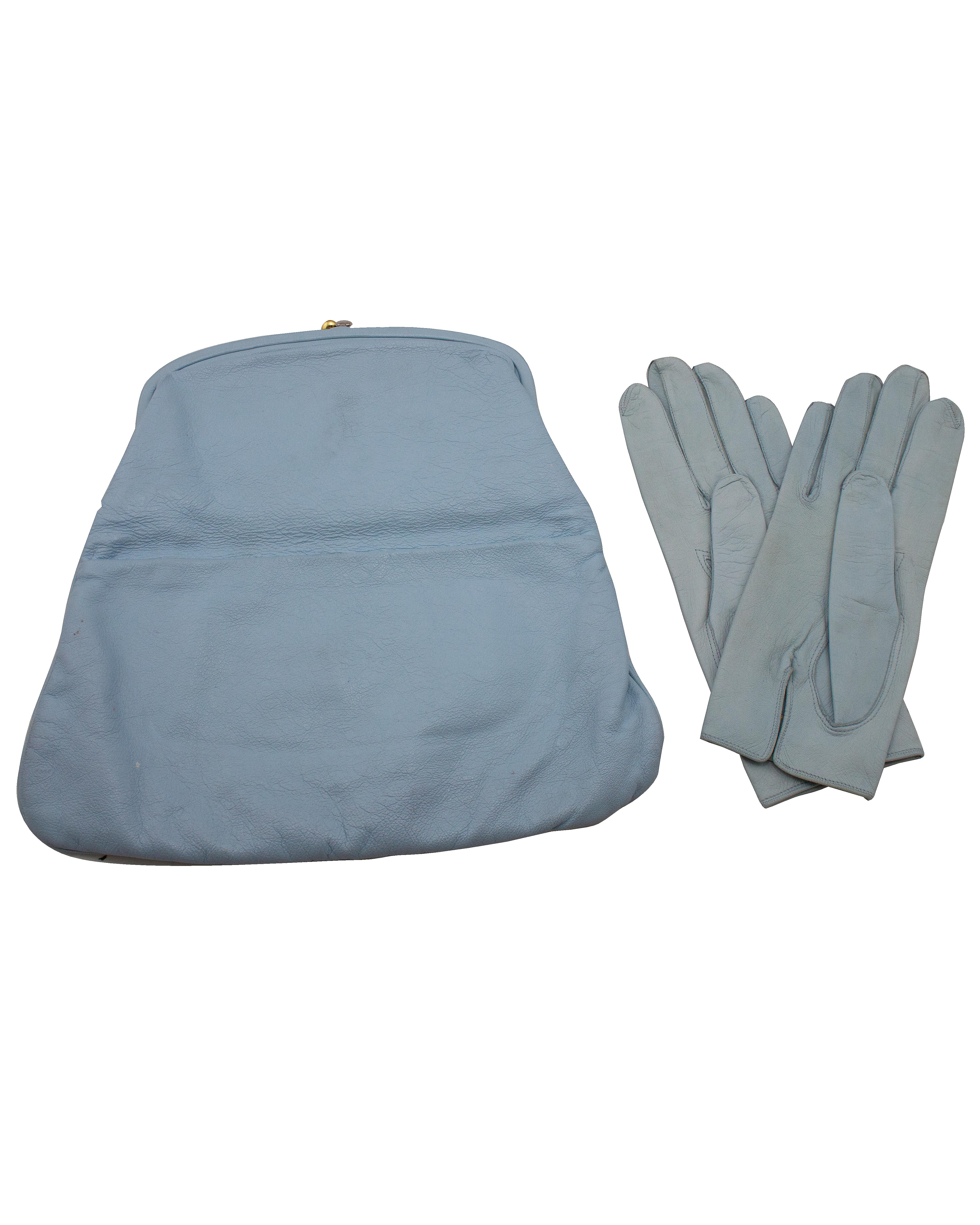 1950's baby blue kid leather classic Coblentz fold over clutch with matching baby blue leather gloves. Rarely found in leather, this classic shape is lined in navy corded silk and closes with a gilt metal hard frame kiss lock. The added feature of