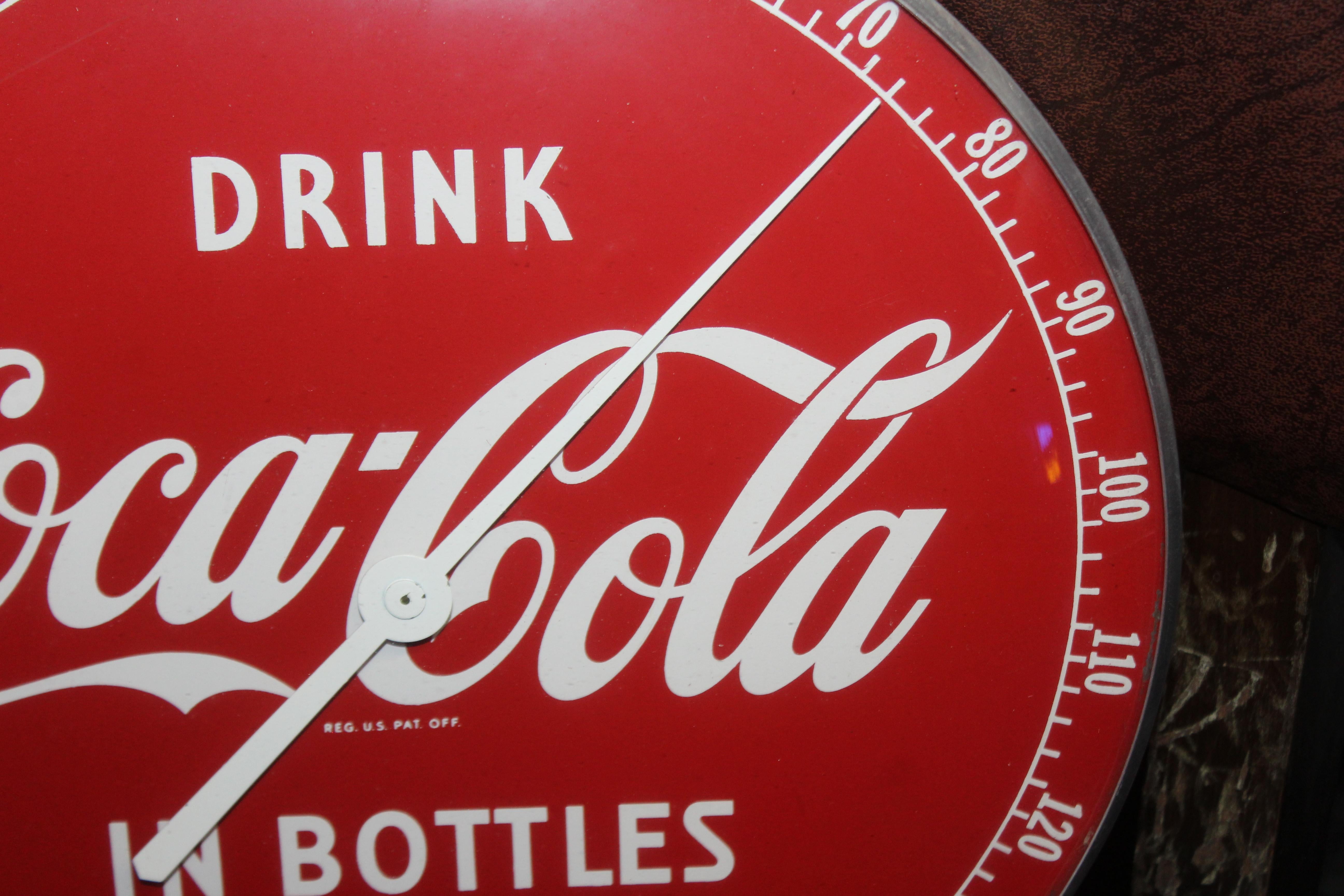 drink coca cola in bottles sign