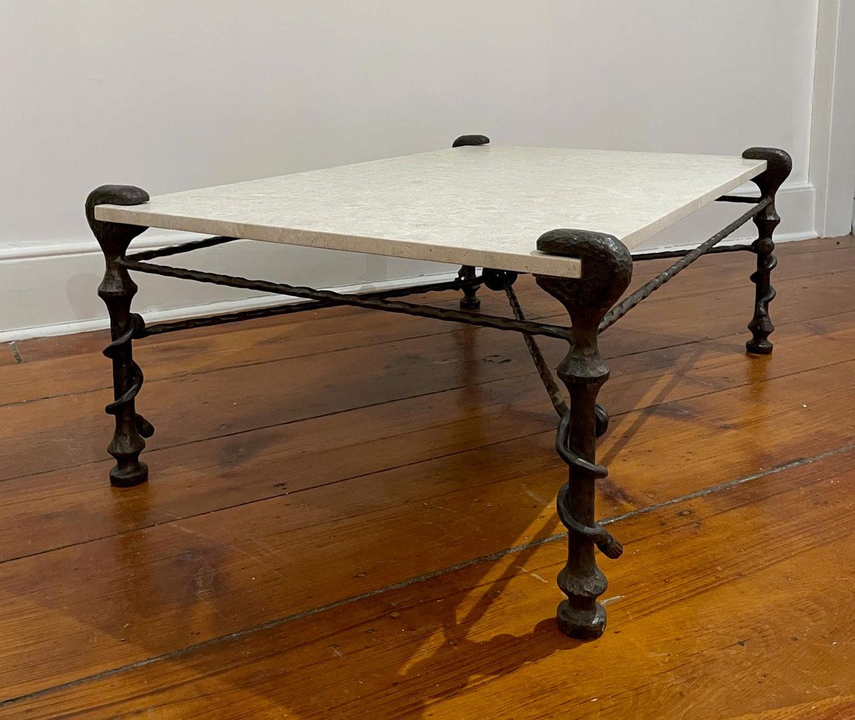 Sculptural wrought iron coffee table, in the manner of Diego Giacometti, circa 1950s with new travertine top. Absolutely stunning.