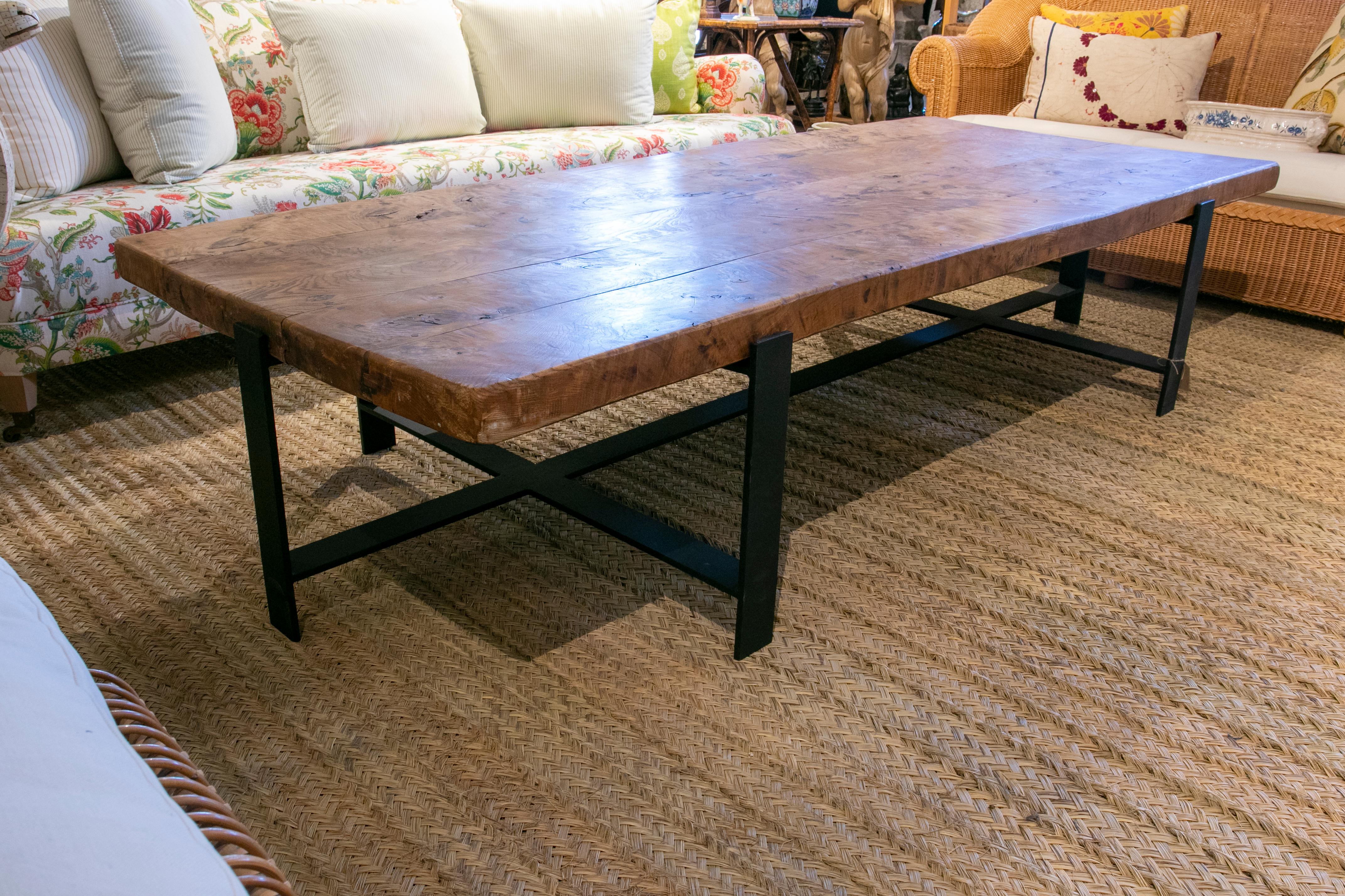 1950s coffee table with wooden table top and modern iron base.