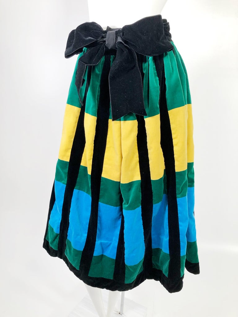 1950s Color block cotton velvet, full gathered skirt In black, emerald, sapphire and gold,  Lining is pink and white.  Waist band and side zipper.  Bow is detachable. Fits a US size medium.