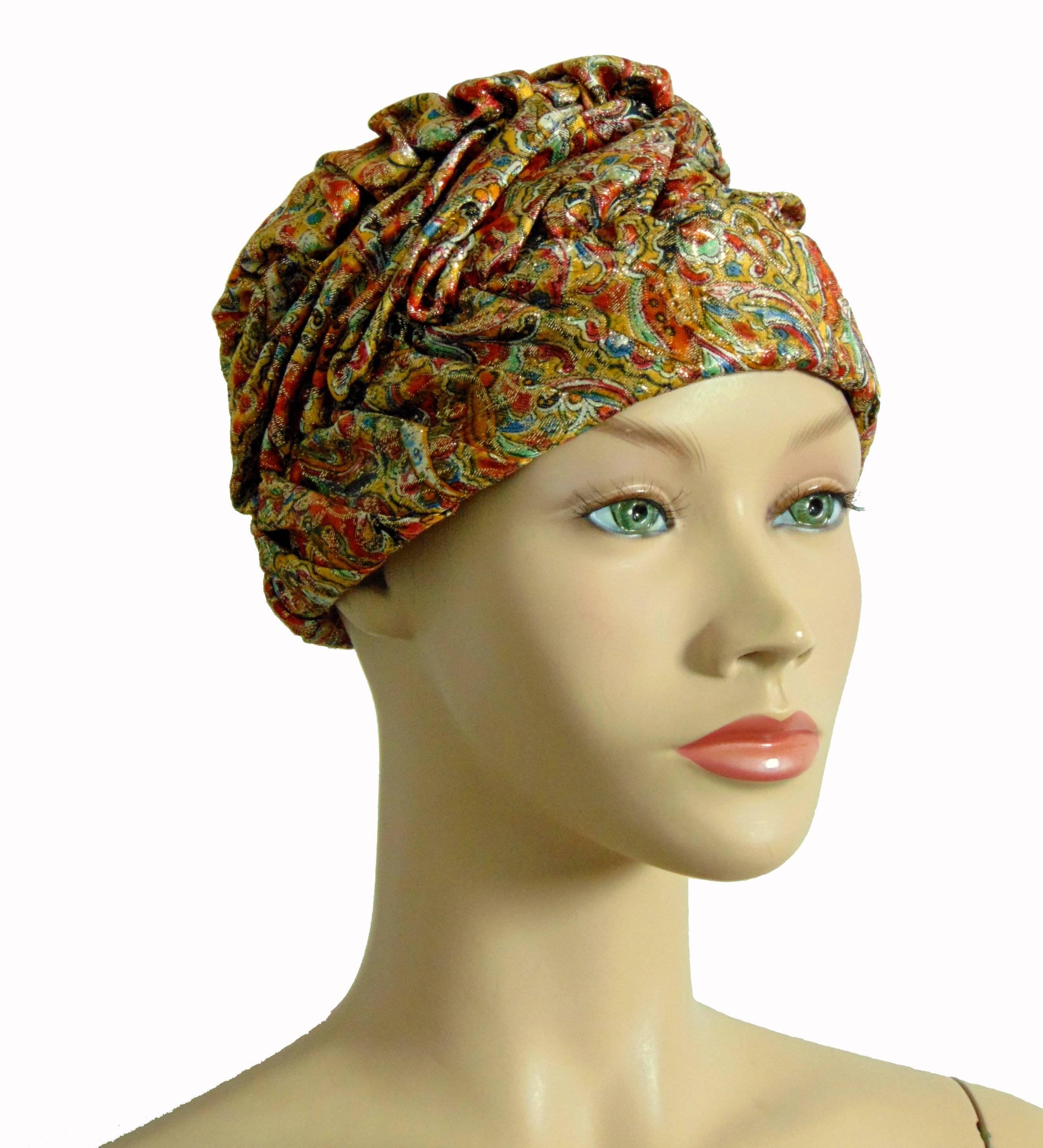 This fabulous hat or turban was made by Marshall Field & Company, most likely in the early 1950s. Made from a shimmery paisley fabric, it is fully lined in cream silk with netting overlay. In excellent condition, this piece would look amazing when