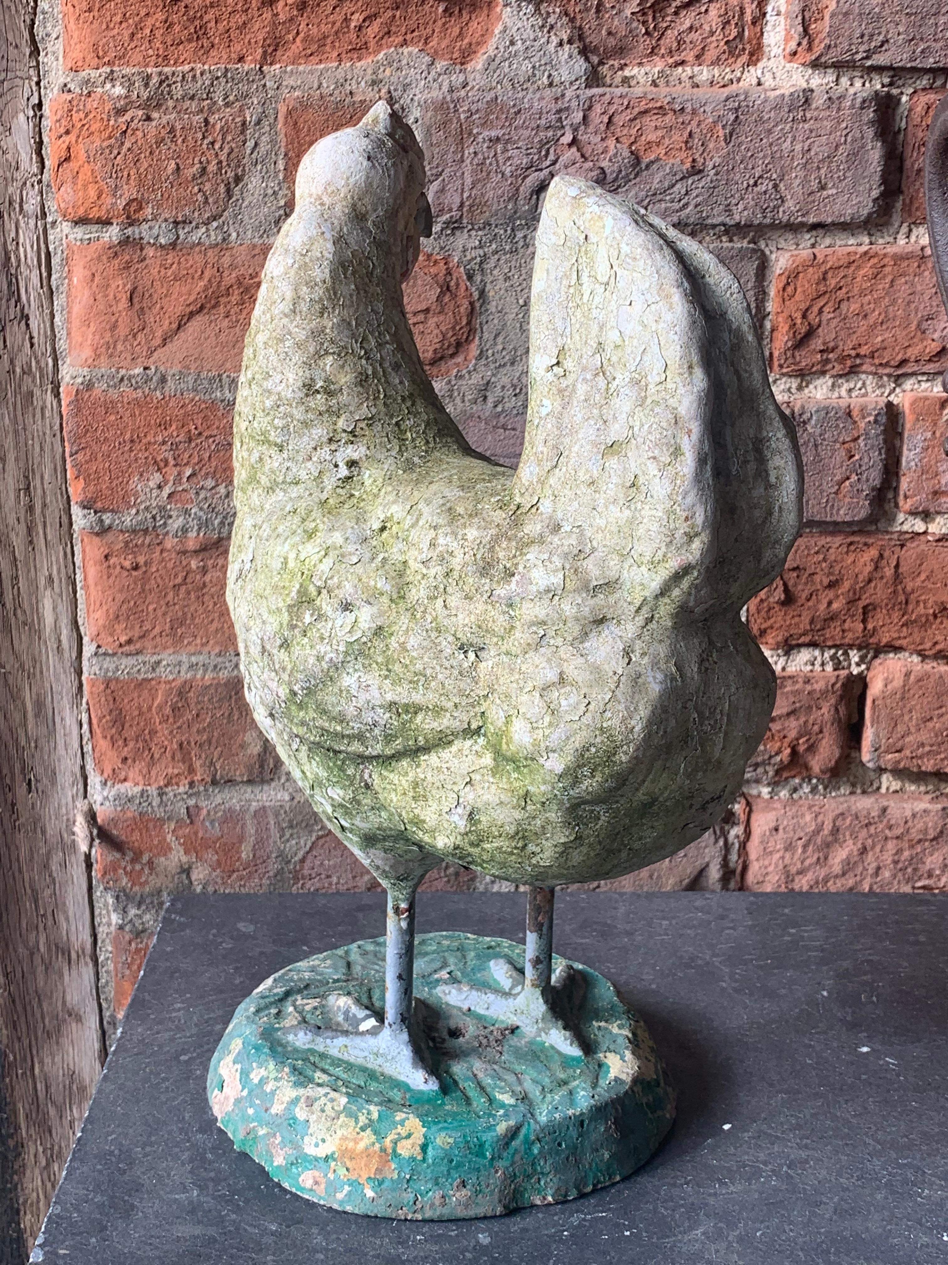 A nice French 1950's composite stone chicken with a nice weathered paint patina. A very well modelled and decorative piece.