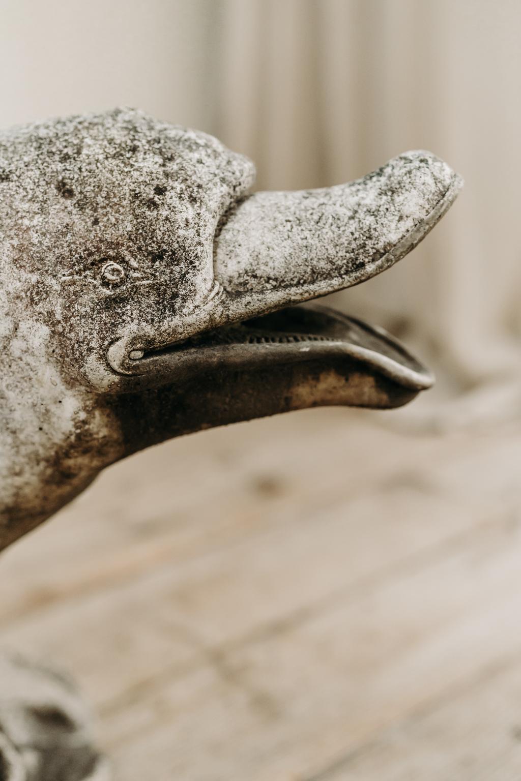 outdoor concrete dolphin statues