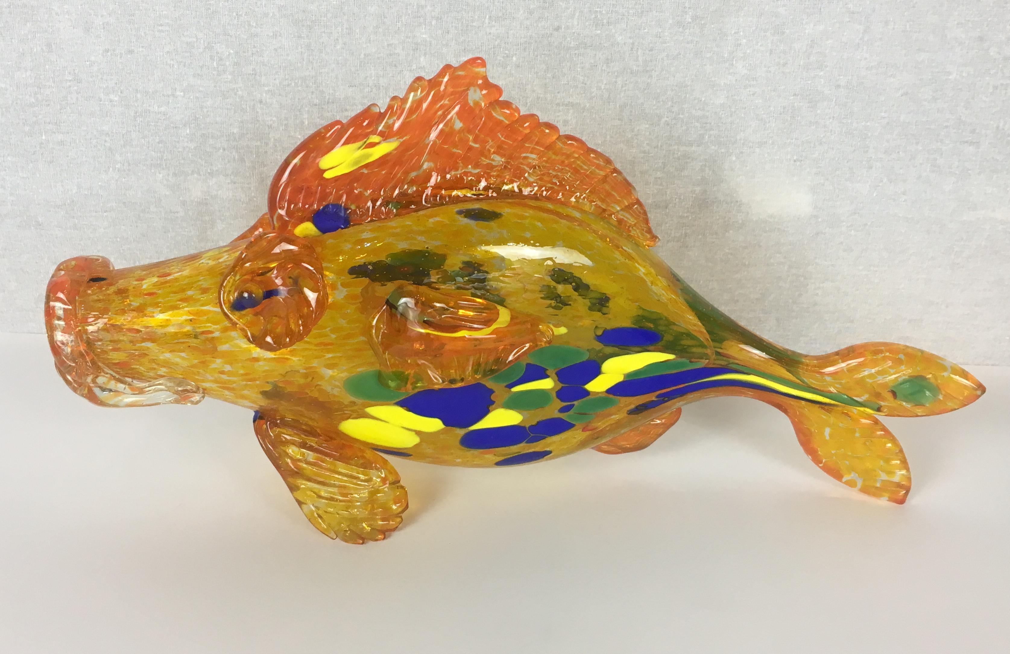Beautiful hand blown yellow, blue, orange and green Murano art glass sculpture with flecks.  This Murano glass fish is from Italy, circa 1950s.

Very decorative, stunning colors when the light shines on it.
Will enhance any shelf, table or