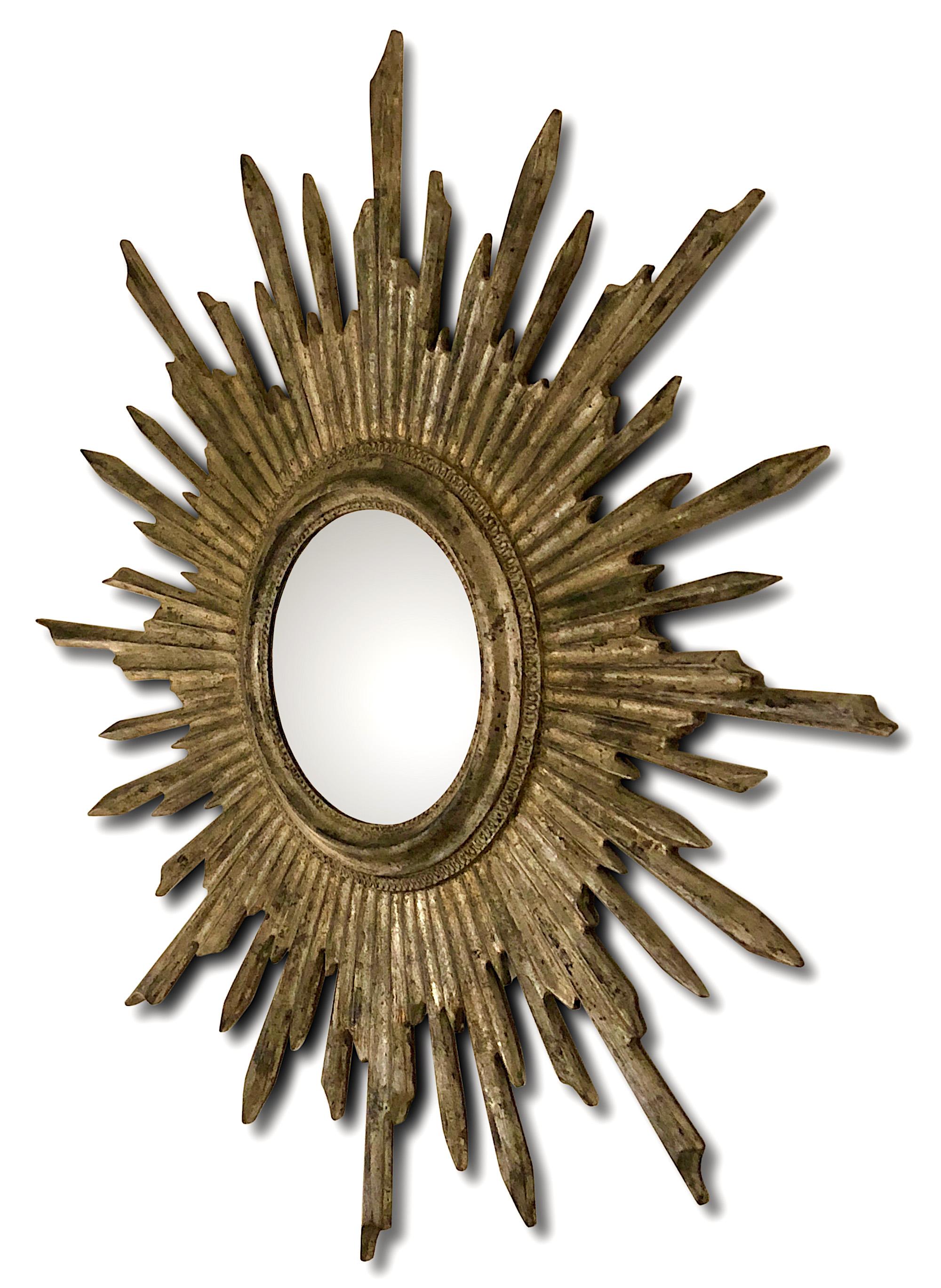 A convex sunburst mirror dating from the mid 1950s with an aged silver gilt leaf finish.

Dimensions
Entire diameter 71cm, Diameter of convex mirror 18cm.