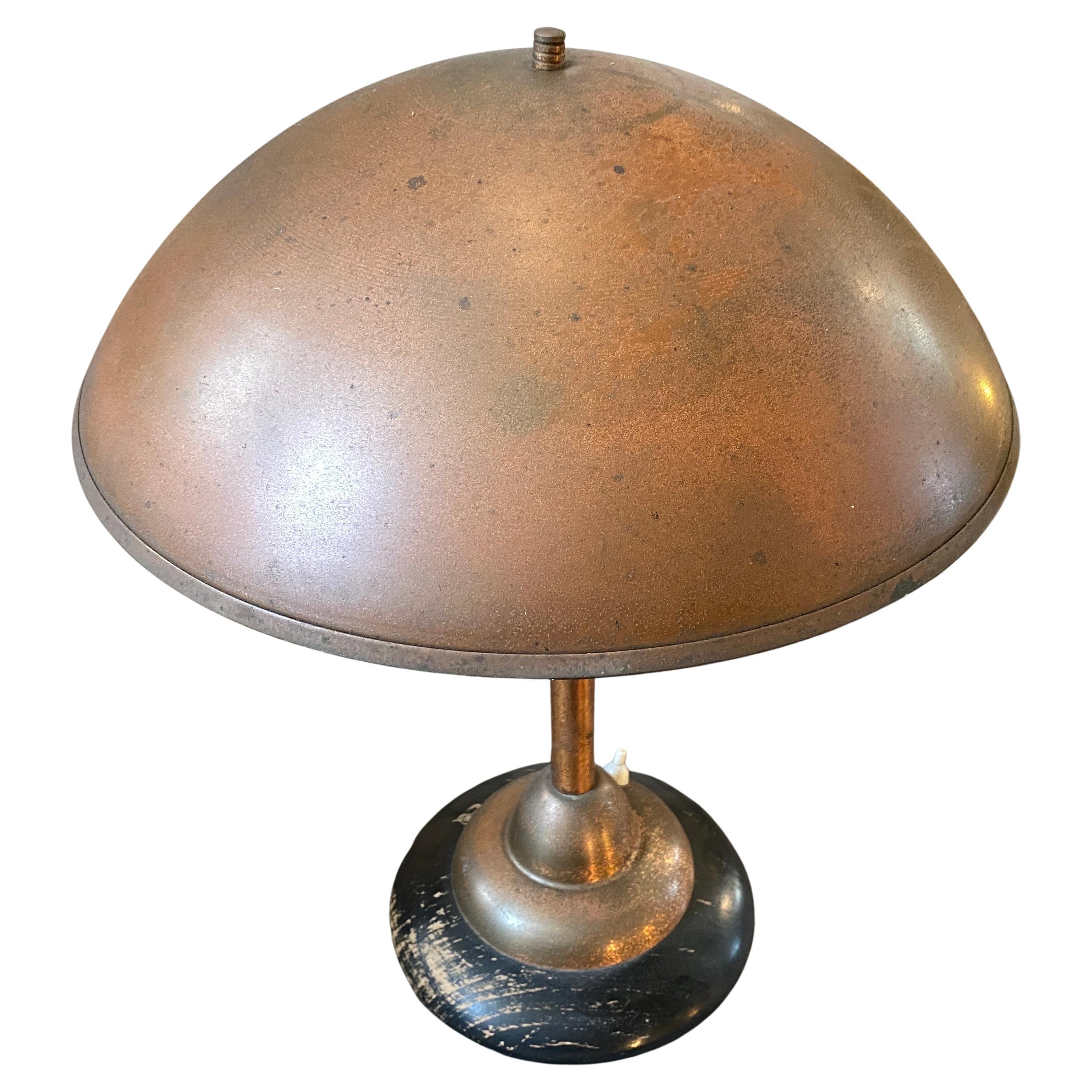 An industrial copper and wood table lamp designed and manufactured in Italy in the Fifties. Copper it's in original patina, black painted wood has signs of use and age that's gives it a superb vintage look. It works both 110-240 volts and needs a