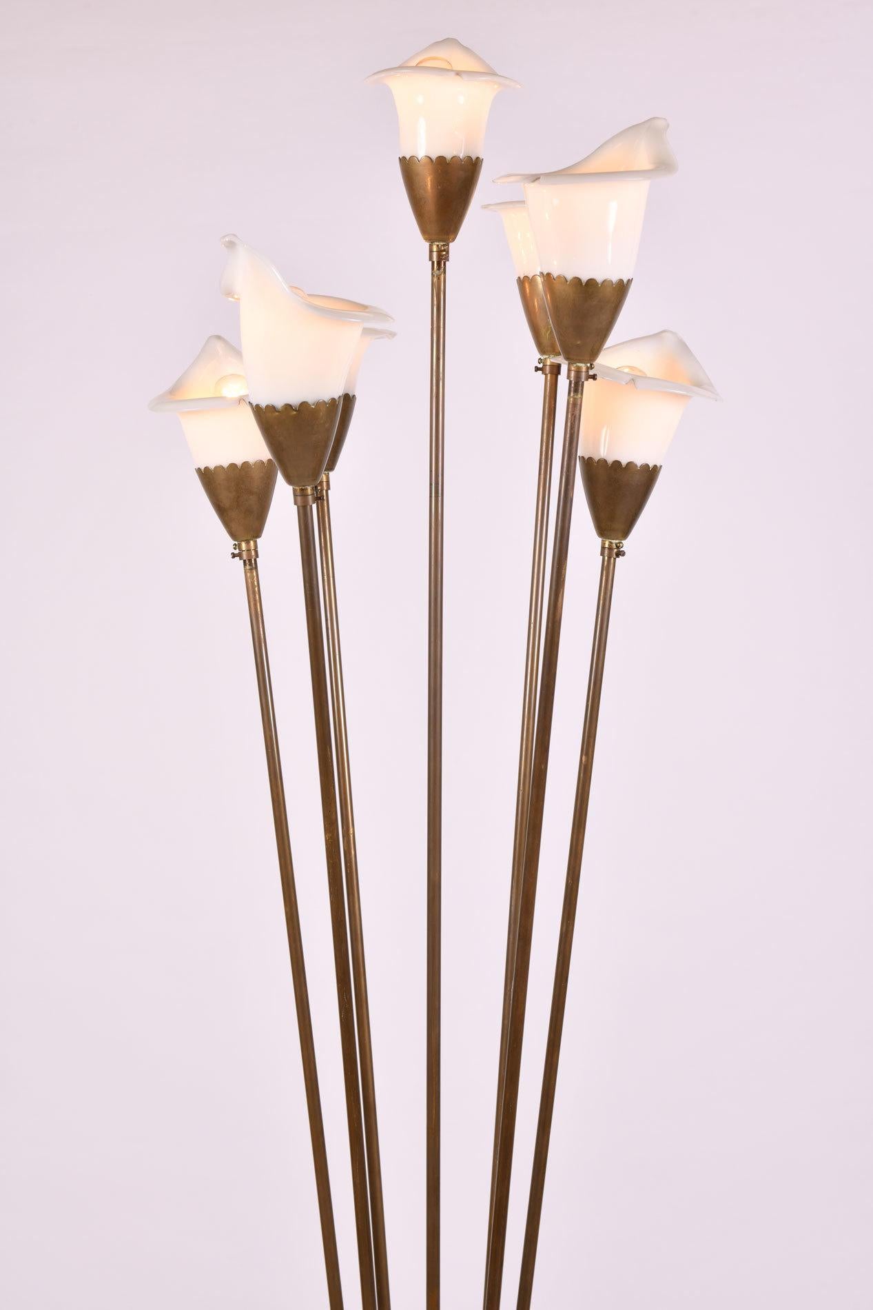 Dramatic seven lilies of hand blown white glass each on a straight brass stem emanating from a double-conical copper vase detailed in brass. Italian, early 1950s.

Angelo Lelli was an influential and important Italian designer of furniture and