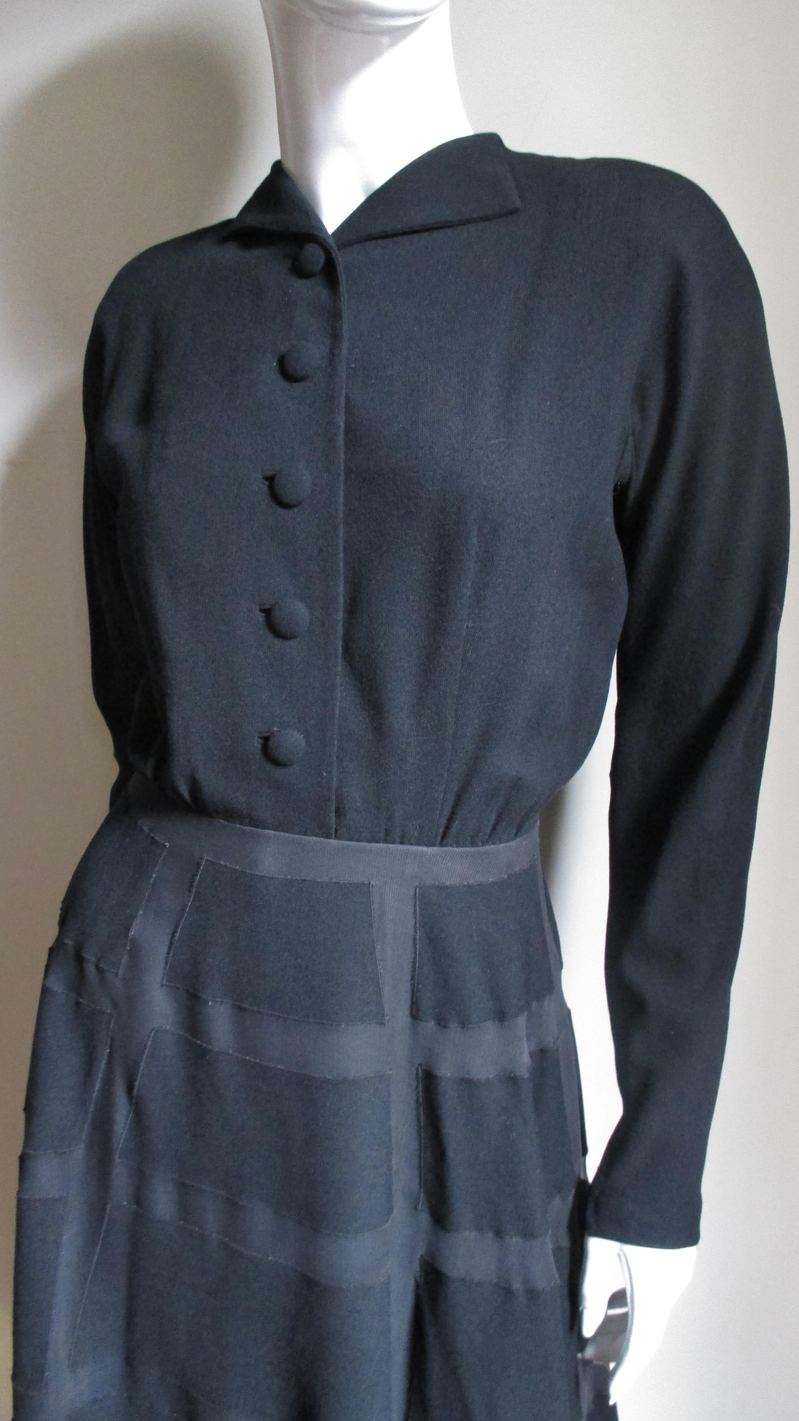 Antonio Castillo was one of the most prominent couturiers to come out of Paris in the 1940s and joined the house of Lanvin in 1950.  This is a stunning black fine wool dress with couture detailing. It has zipper cuffed dolman sleeves, a wing collar