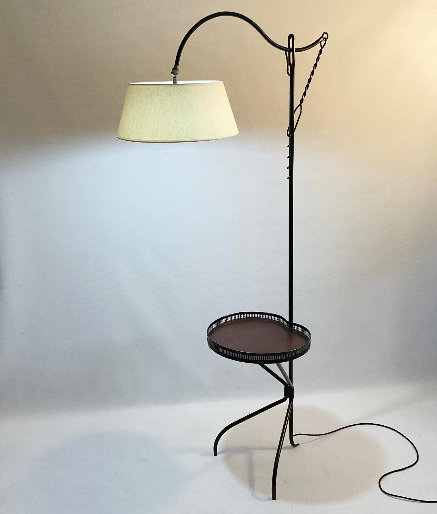 1950s French wrought iron floor lamp with side table and adjustable arm support with a system called 