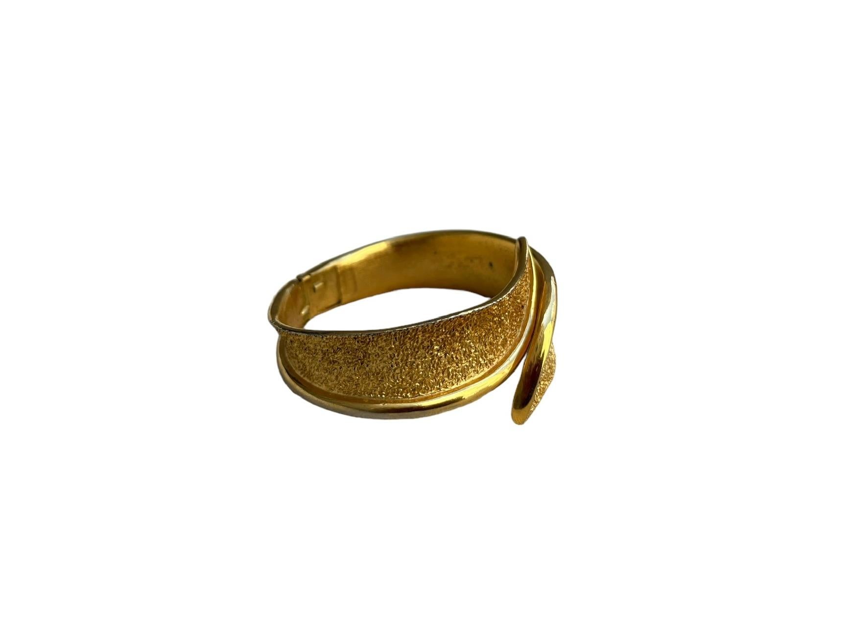 1950s Crown Trifari clamper bracelet.
Textured gold trifanium bracelet with sleek rimmed edges.
Interior side is just as gorgeous in brushed gold
A beautiful curved design
This bracelet is ideal for a small wrist; my wrist is 5 3/4 and the bracelet