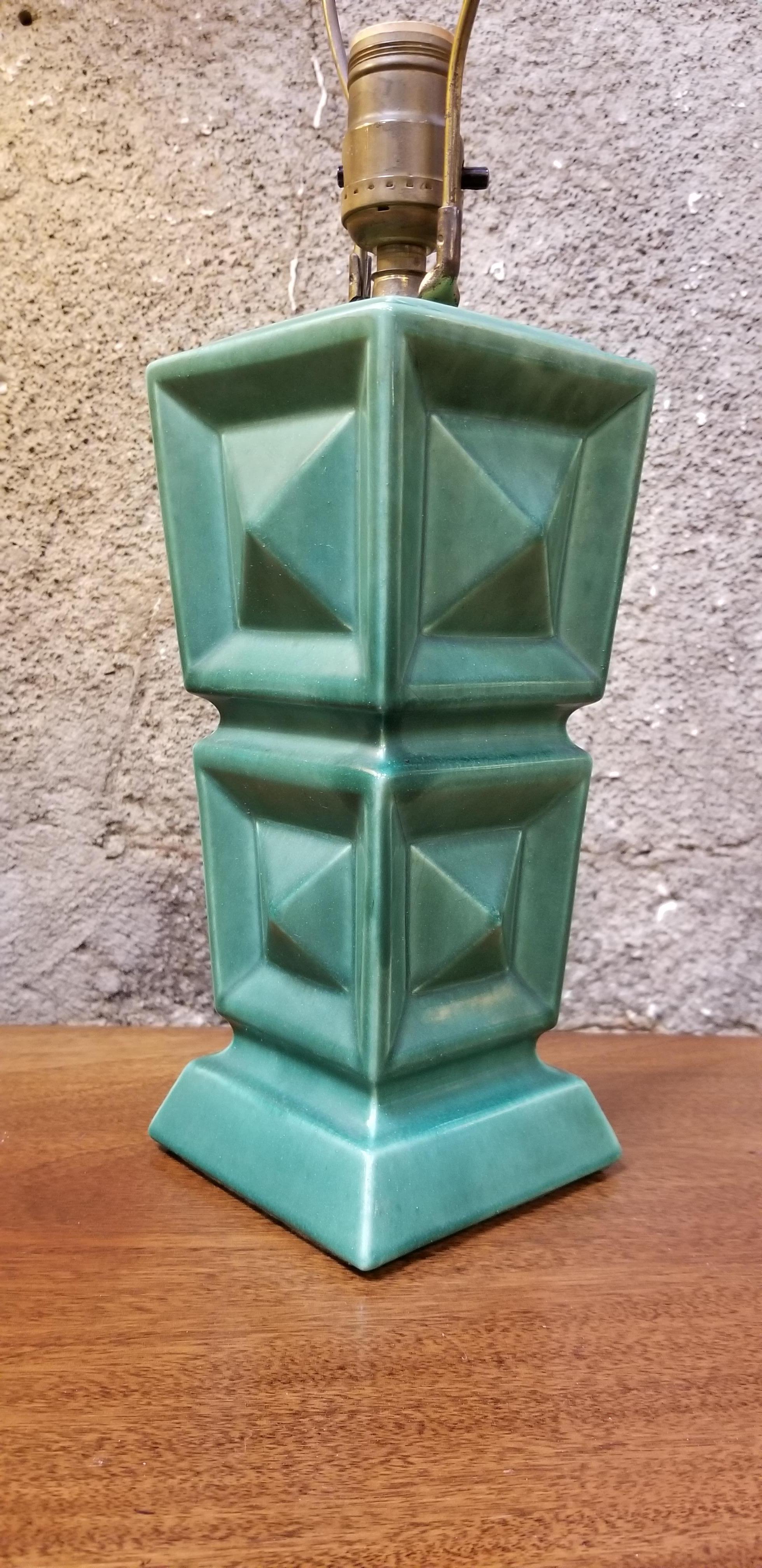 Unique 1950s cubical green ceramic lamp with original decorated paper lamp shade. Conical stacked cubes with pyramid detail. Printed shade with matching cubical detail. Very nice original vintage condition. Great shade! Ceramic base only measures