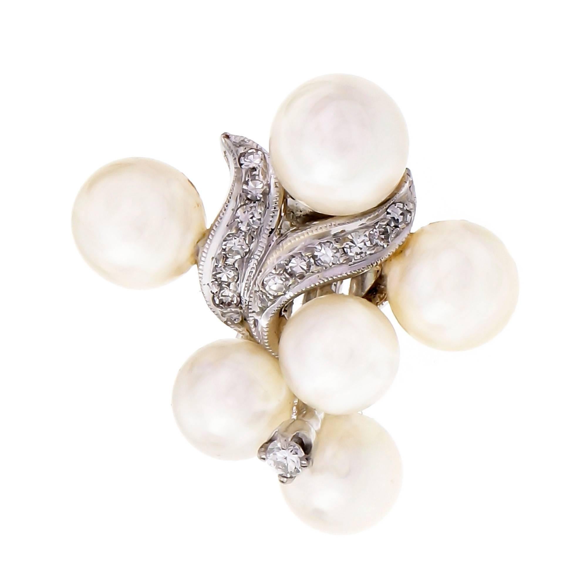 Mid-century vintage 1950s clip post cultured Pearl and Diamond 14k white gold earrings.

12 round white cultured Pearls with good lustré and few blemishes, 6 – 7mm 
22 round single cut Diamonds, approx. total weight .22cts, G, VS
2 round full cut