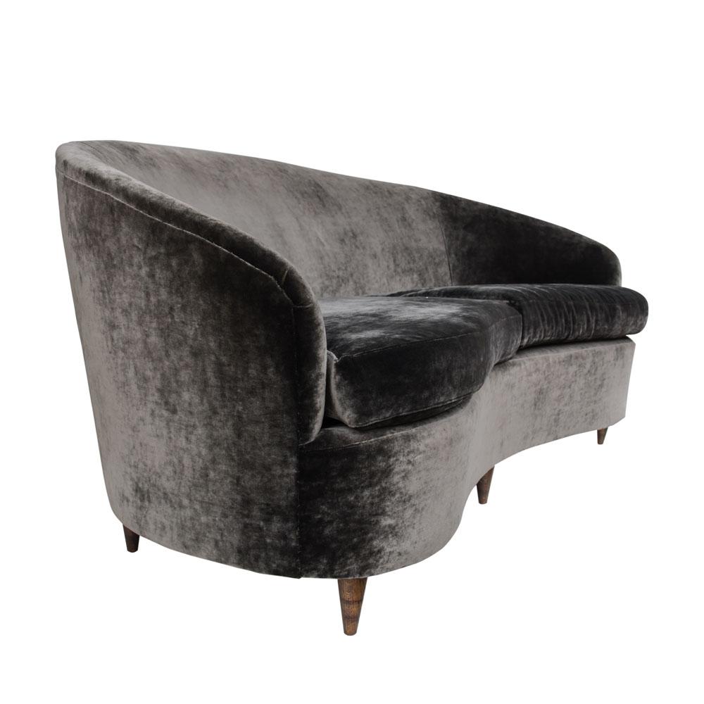 A late 1940s early 1950s outstanding Italian design curved back sofa. Charcoal gray velvet upholstery redone in accordance to the original elegant style , tapered dark wooden feet
Italian design attributed to Guglielmo Ulrich
This sofa is very