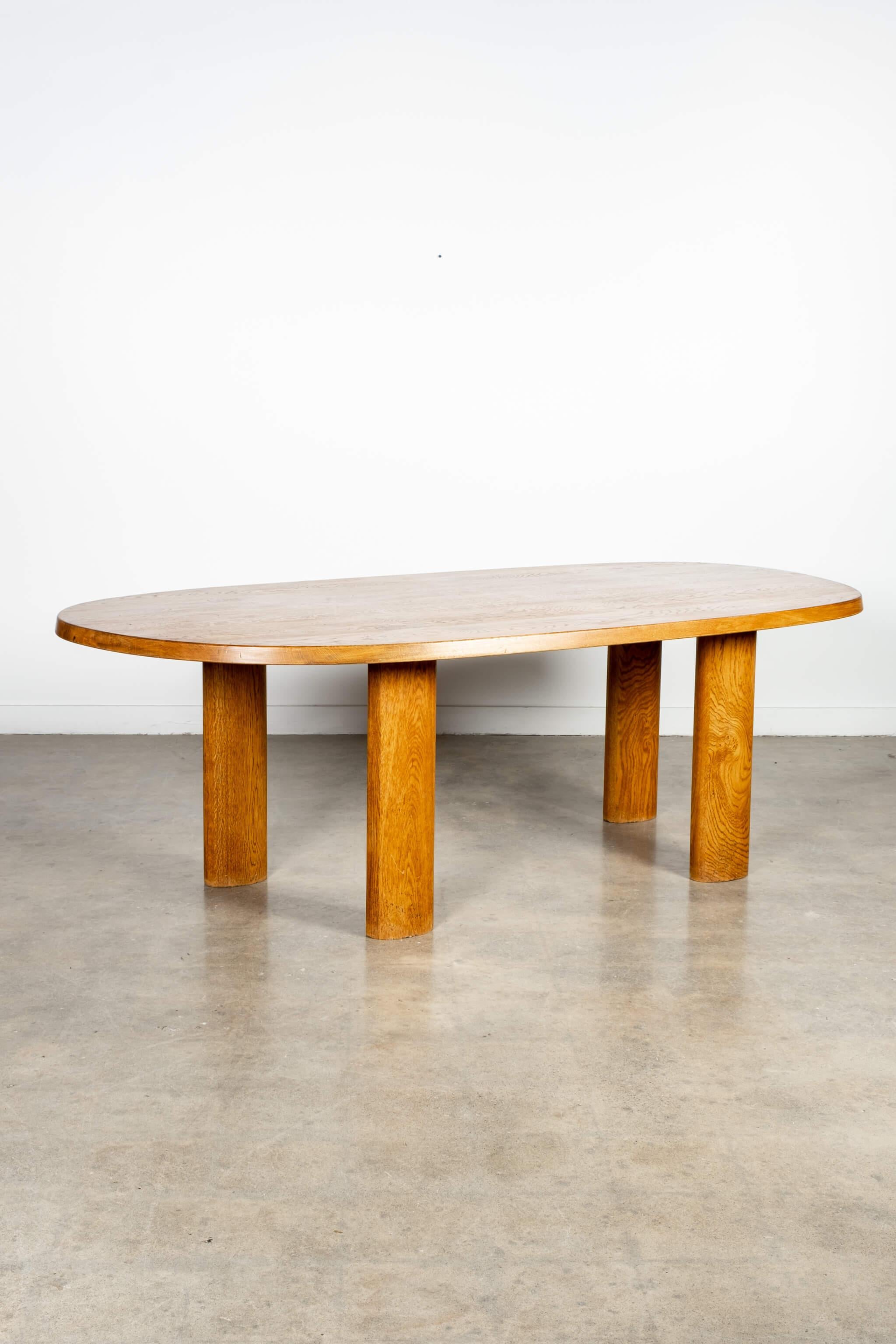 A contemporary to Charlotte Perriand's 'En Forme Libre' wood table, this 1950s dining table is all rounded edges and asymmetrical lines - with a modest organic shape and 4 cylindrical oval legs of solid wood. A testament to 1950s French furniture