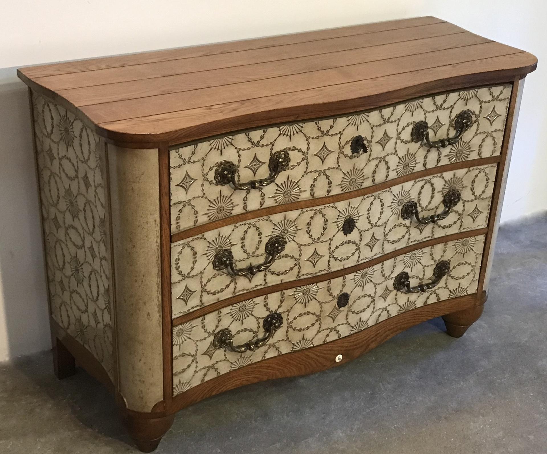 This ornate 1950s three-drawer chest was custom designed for Christian Dior for his Paris office on Avenue Montaigne for many years.
The sides and drawers are made of oak, finished with Coromandel lacquer and embossed classical pattern.
A great