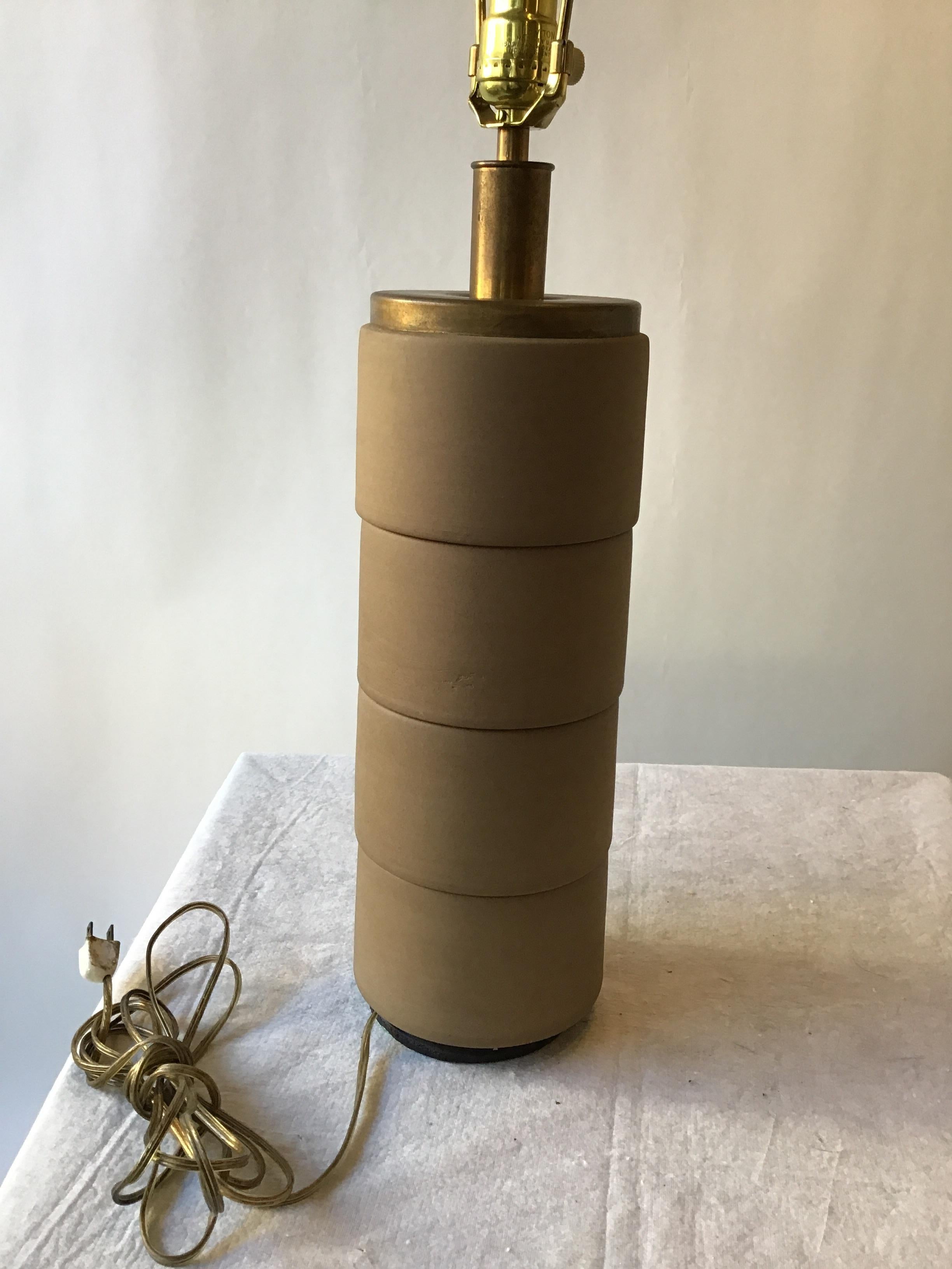 1950s cylindrical ceramic and brass lamp. Needs rewiring. Quite heavy.