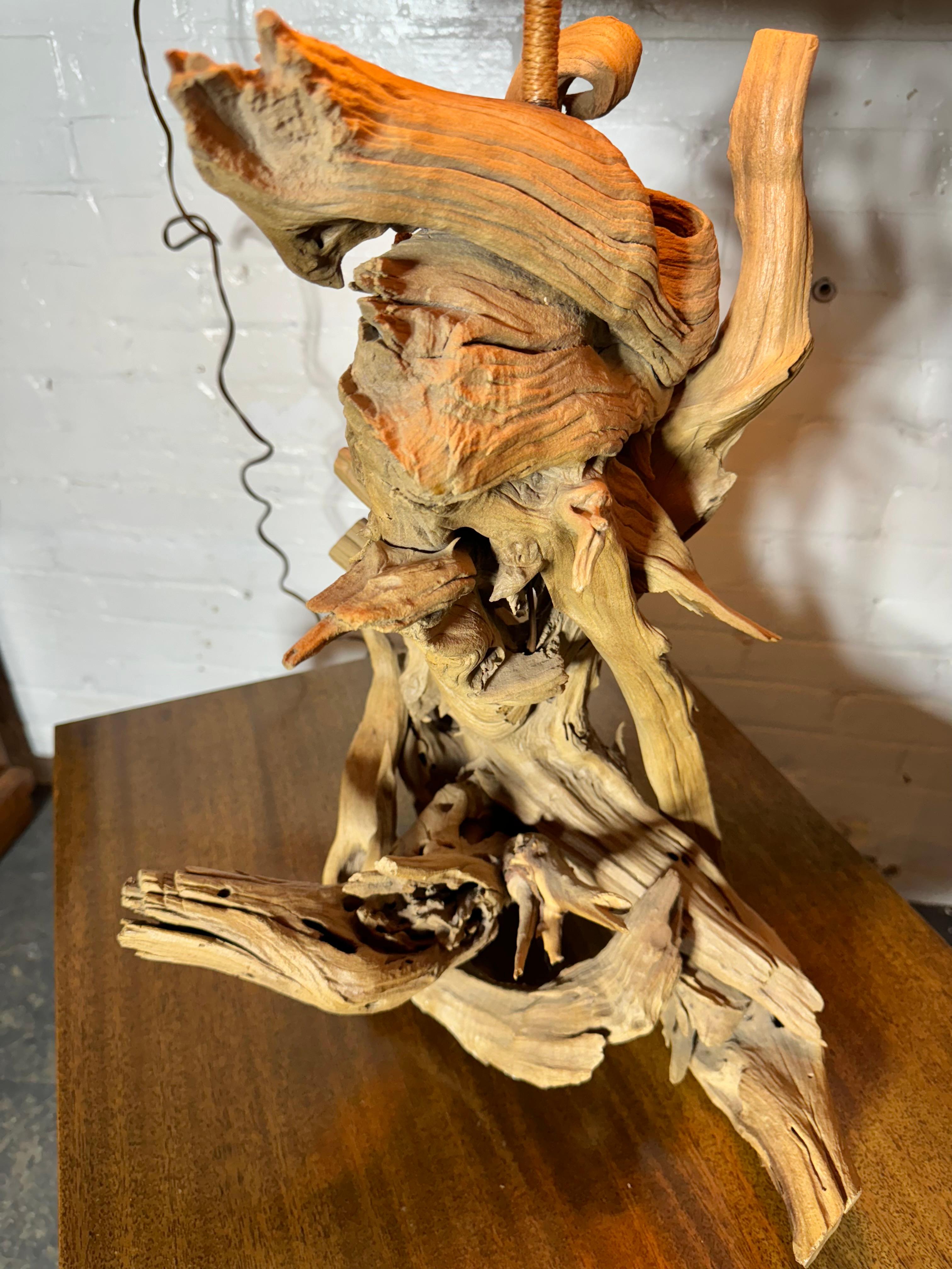 1950s Cyprus / Driftwood lamp with original Sabutan Palm Shade and finial.. Hand woven palm lampshade.. Retains original finial (usually missing).. 