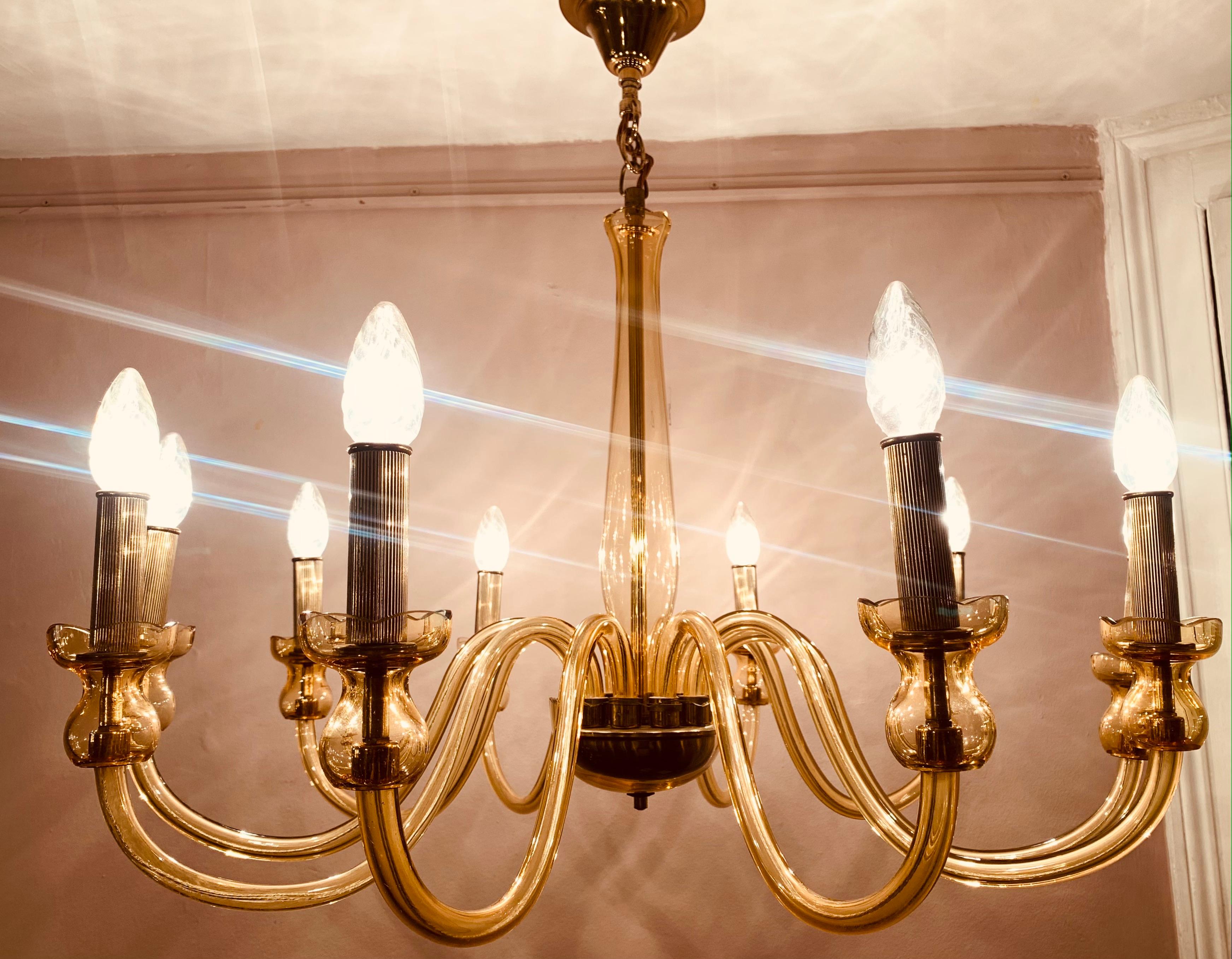 1950s 10 arm hand blown chandelier made from Bohemian crystal yellow-tinted glass with polished brass fittings. Handcrafted in the Czech Republic. The ribbed brass candle bulb holders feature indented lines running vertically. A very glamorous