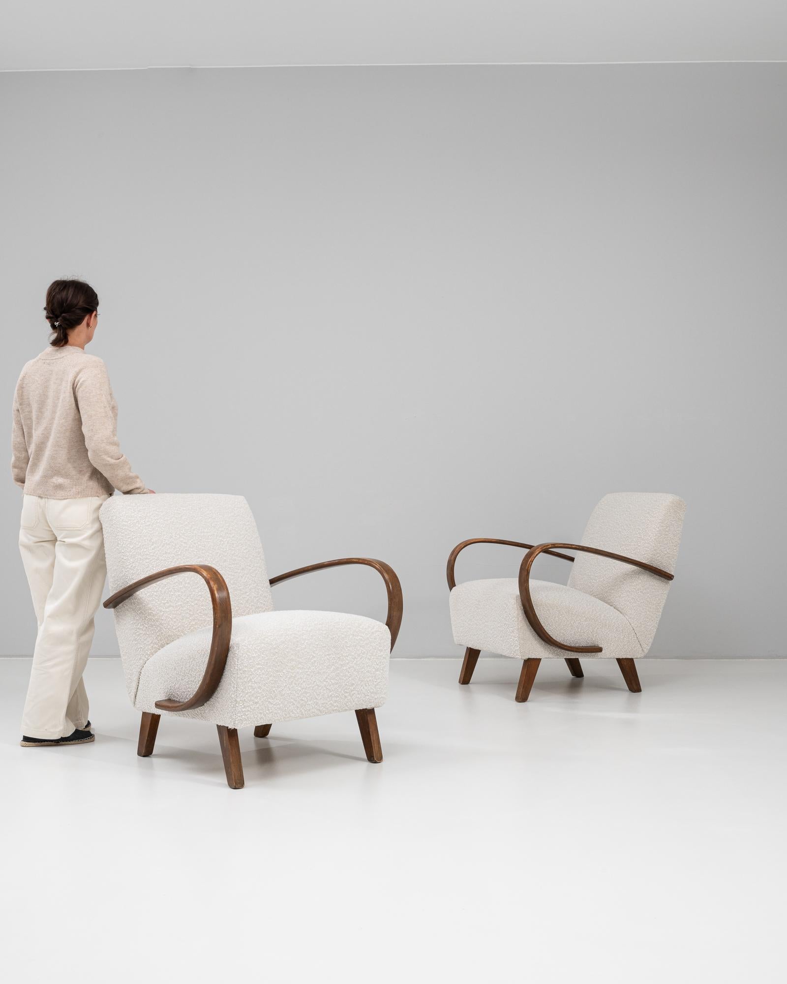 This 1950s Czech pair of upholstered armchairs by Jindřich Halabala exemplifies the elegance and innovation of mid-century modern design. Characterized by Halabala’s iconic sweeping bentwood arms, the chairs combine sculptural form with ergonomic