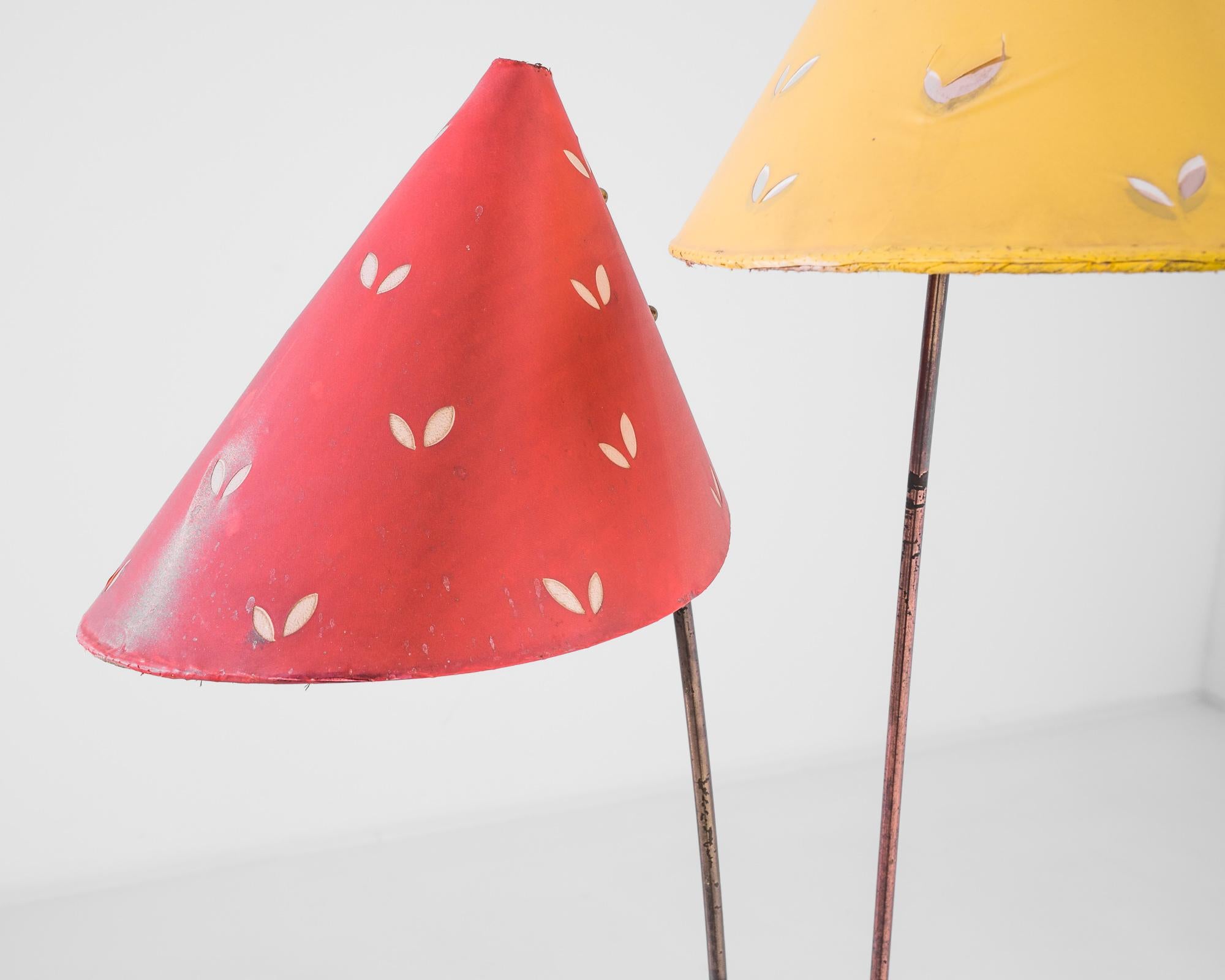 Step into the retro ambiance of the mid-20th century with this captivating 1950s Czech Metal Floor Lamp. Its dual-cone design, featuring a vibrant red and a sunny yellow shade, is sure to inject a playful pop of color into any interior. Each cone is
