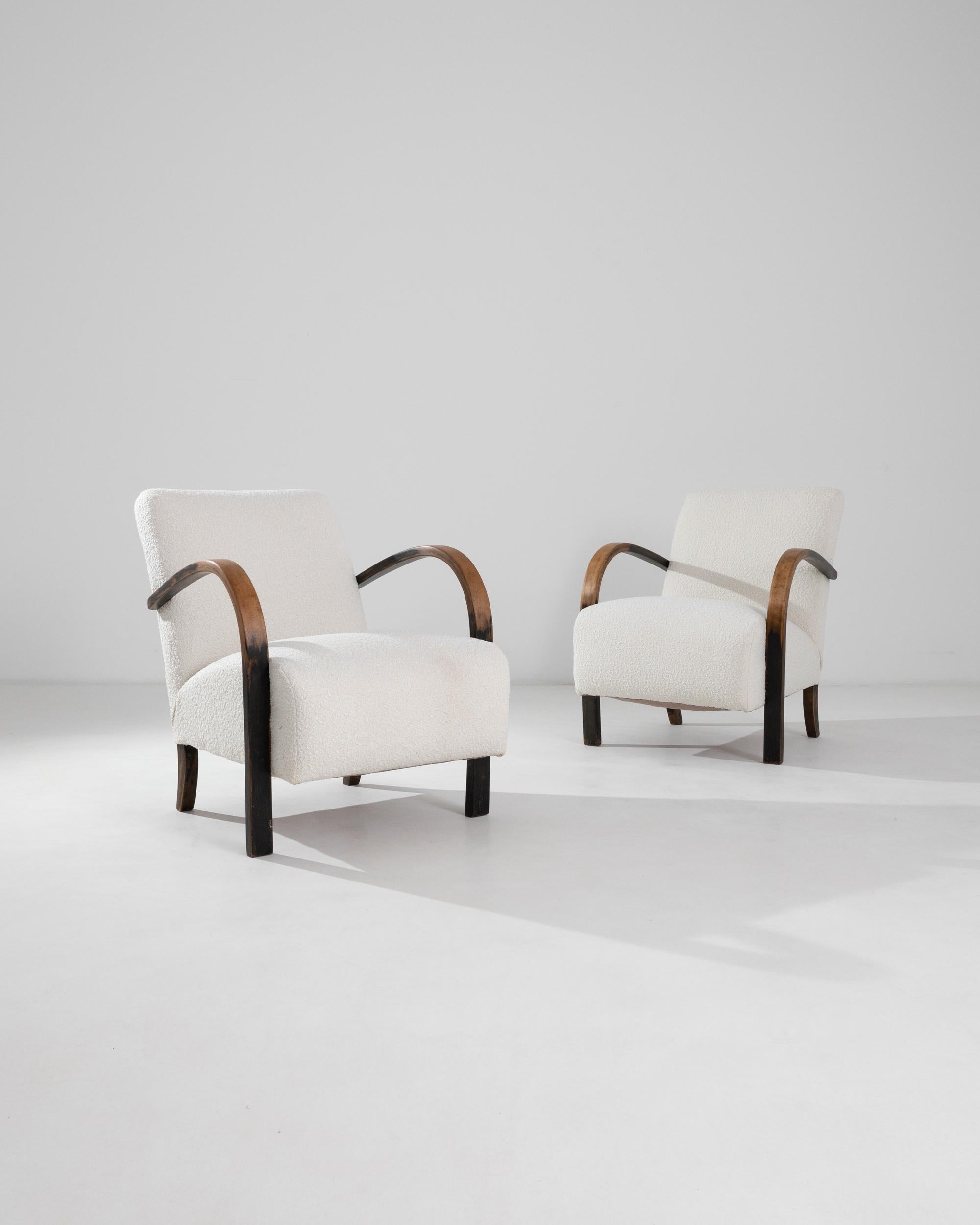 These sculptural armchairs, designed in Czechia around 1950, showcase the flowing outlines of their bentwood armrests, complementing the smooth curves of the back legs. Attributed to designer Jindrich Halabala, these chairs exhibit a typical Central