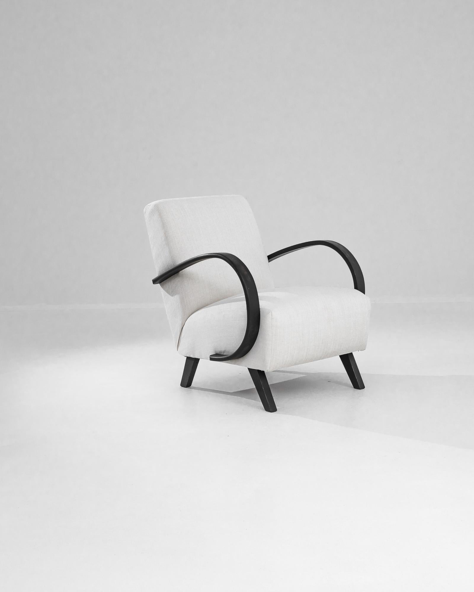 Add a touch of Art Deco elegance to your home with this stunning 1950s Czech Wooden Armchair by J. Halabala. Renowned for his innovative designs, Halabala's craftsmanship is evident in this exquisite piece, featuring gracefully curved wooden