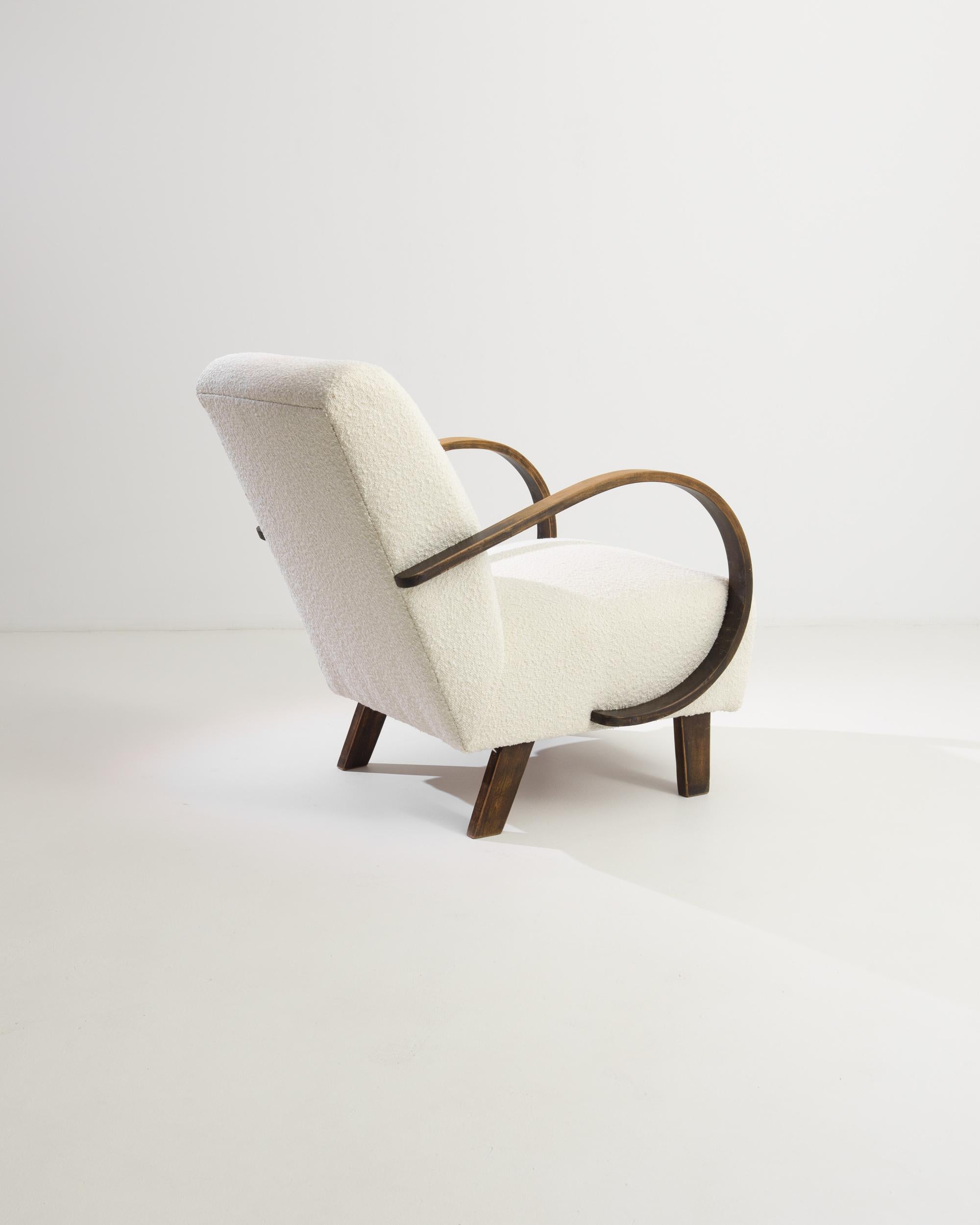 Introduce a touch of mid-century modern elegance to your home with this exquisite 1950s Czech Wooden Armchair by the acclaimed designer J. Halabala. This iconic piece features gracefully curved wooden armrests that add a distinctive and