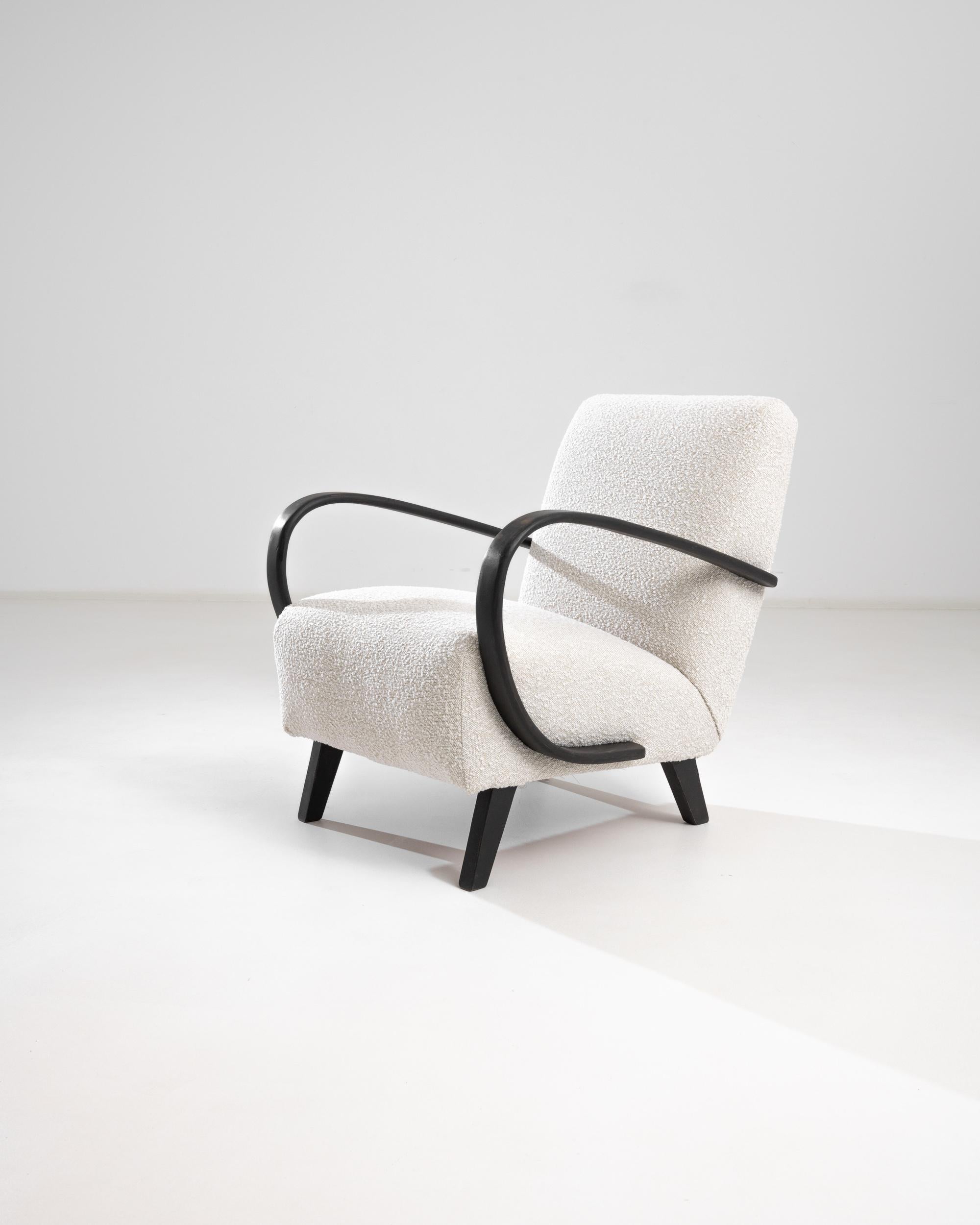 Introducing the 1950s Czech Wooden Armchair by J. Halabala, a timeless piece that combines vintage charm with modern comfort. This exquisite armchair features elegantly curved wooden armrests that provide a striking contrast to its plush, textured