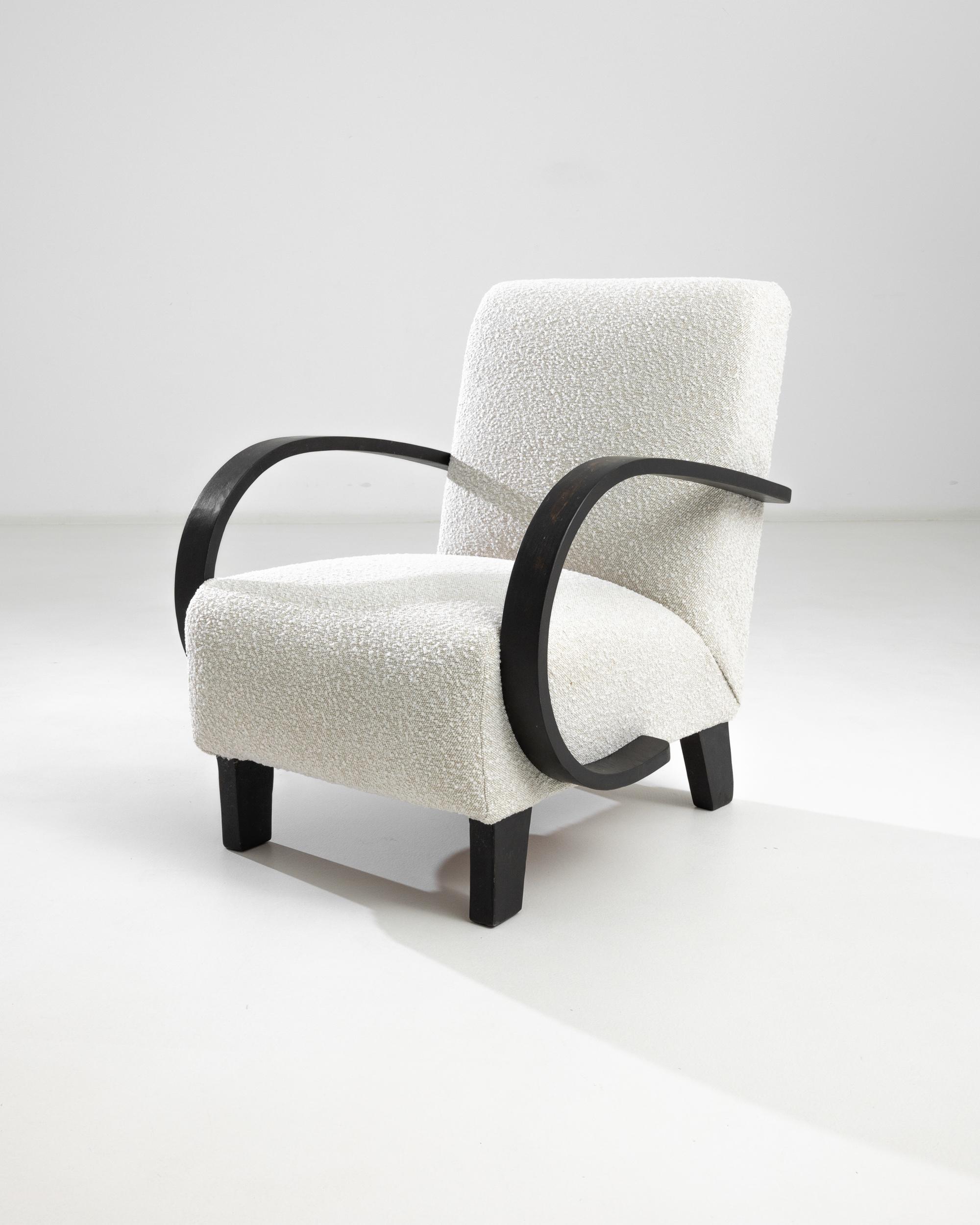 Introducing the 1950s Czech Wooden Armchair by J. Halabala, a timeless piece that combines vintage charm with modern comfort. This exquisite armchair features elegantly curved wooden armrests that provide a striking contrast to its plush, textured