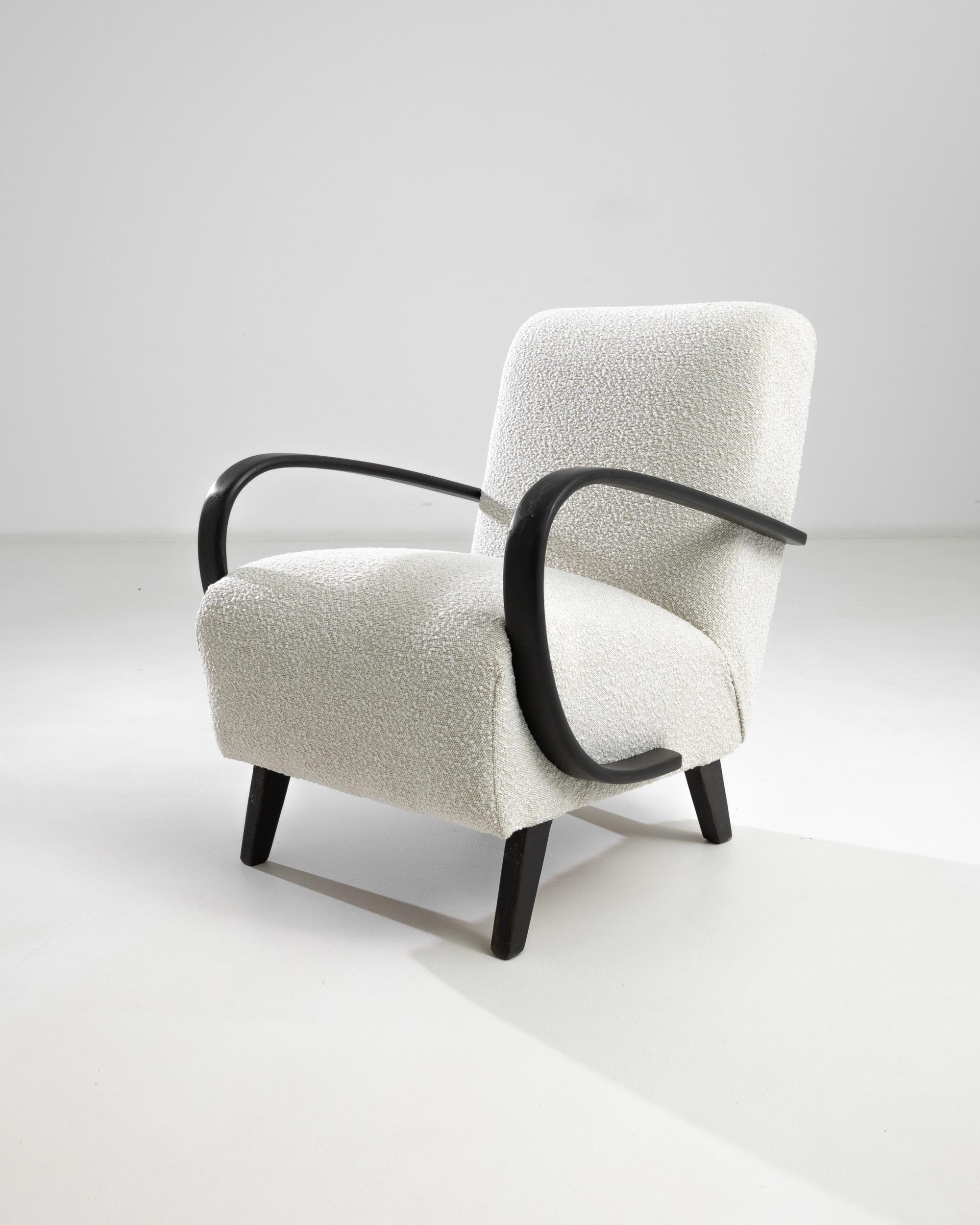 Introducing the 1950s Czech Wooden Armchair by J. Halabala, a timeless piece that combines vintage charm with modern comfort. This exquisite armchair features elegantly curved wooden armrests that provide a striking contrast to its plush, textured