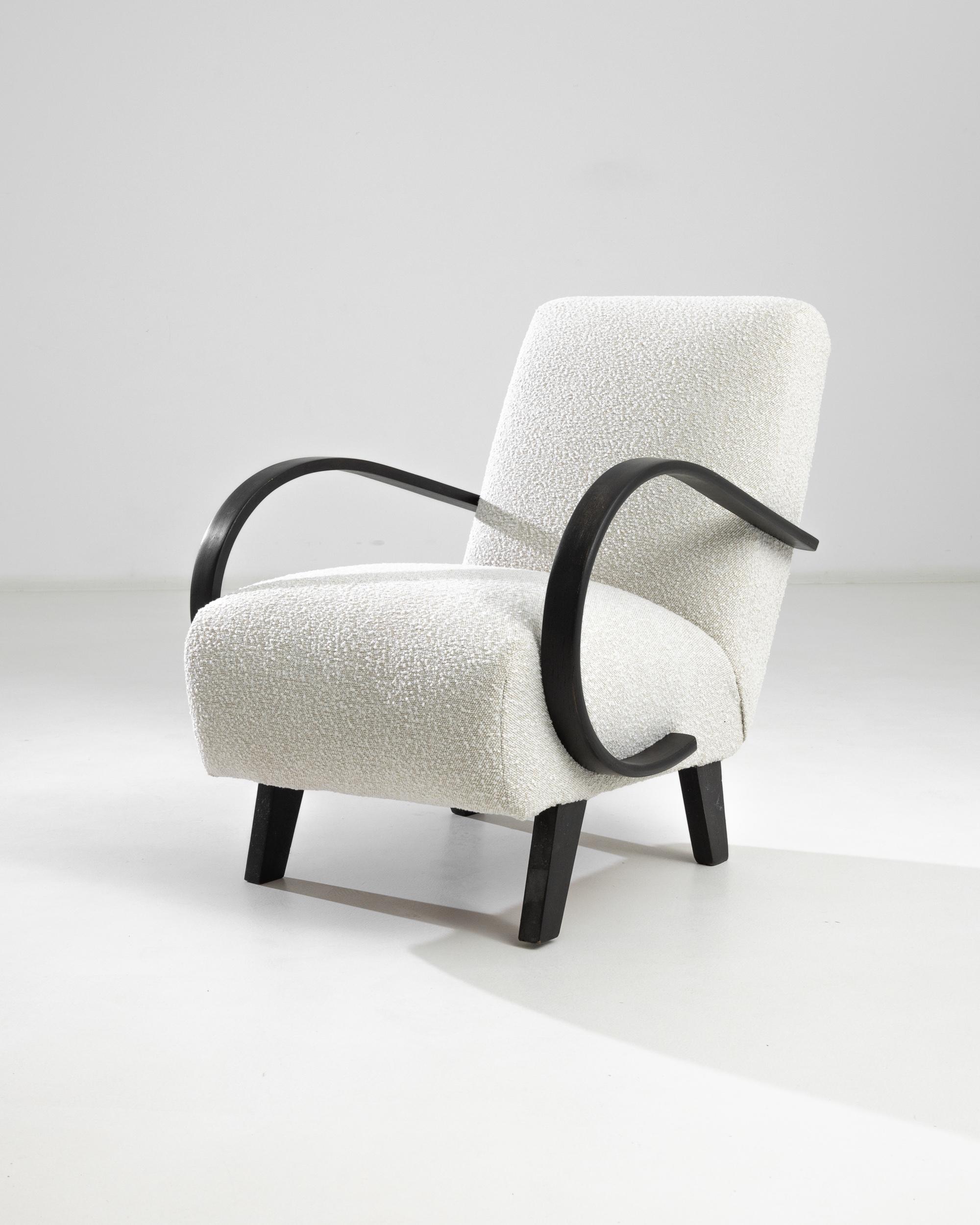 Introducing the 1950s Czech Wooden Armchair by J. Halabala, a timeless piece that combines vintage charm with modern comfort. This exquisite armchair features elegantly curved wooden armrests that provide a striking contrast to its plush, textured