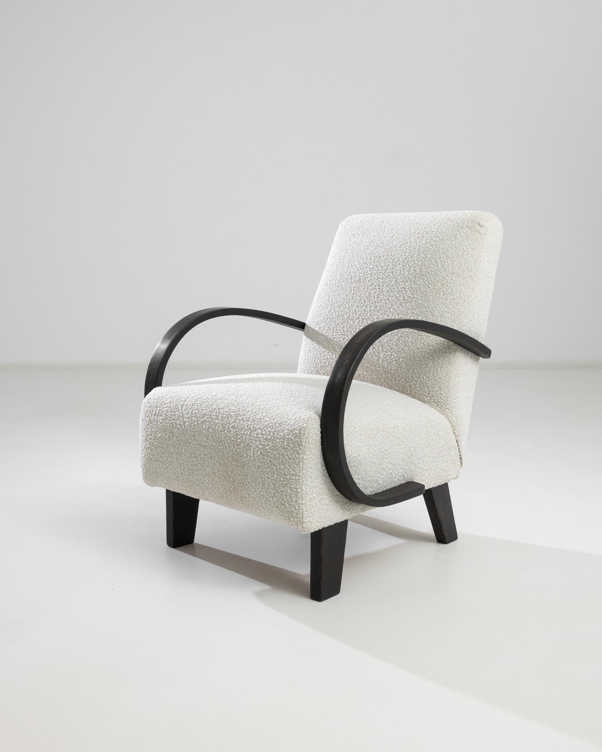 Introducing the 1950s Czech Wooden Armchair by J. Halabala, a timeless piece that combines vintage charm with modern comfort. This exquisite armchair features elegantly curved wooden armrests that provide a striking contrast to its plush, textured