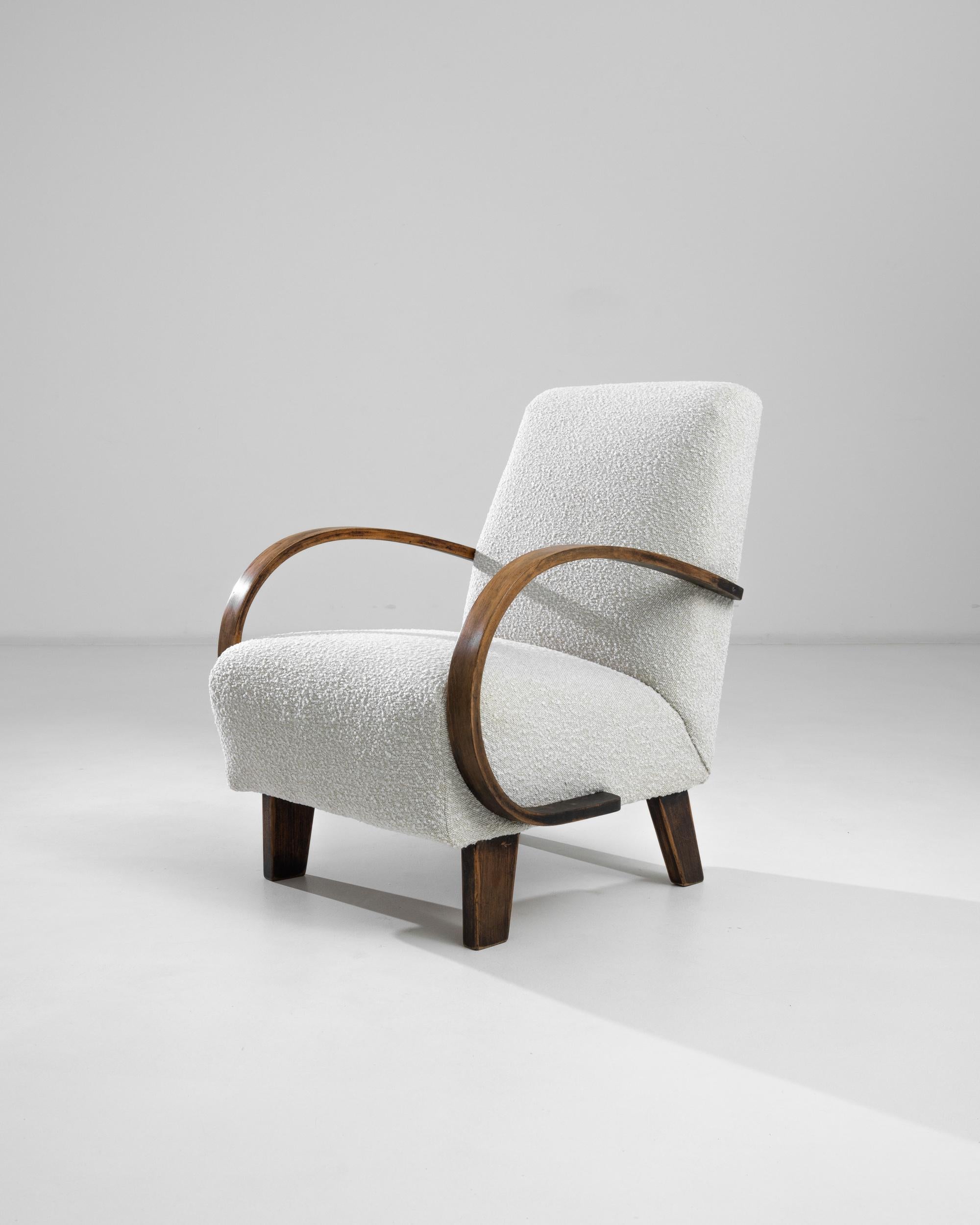 Introducing the 1950s Czech Wooden Armchair by J. Halabala, a timeless piece that combines vintage charm with modern comfort. This exquisite armchair features elegantly curved wooden armrests that provide a striking contrast to its plush, textured
