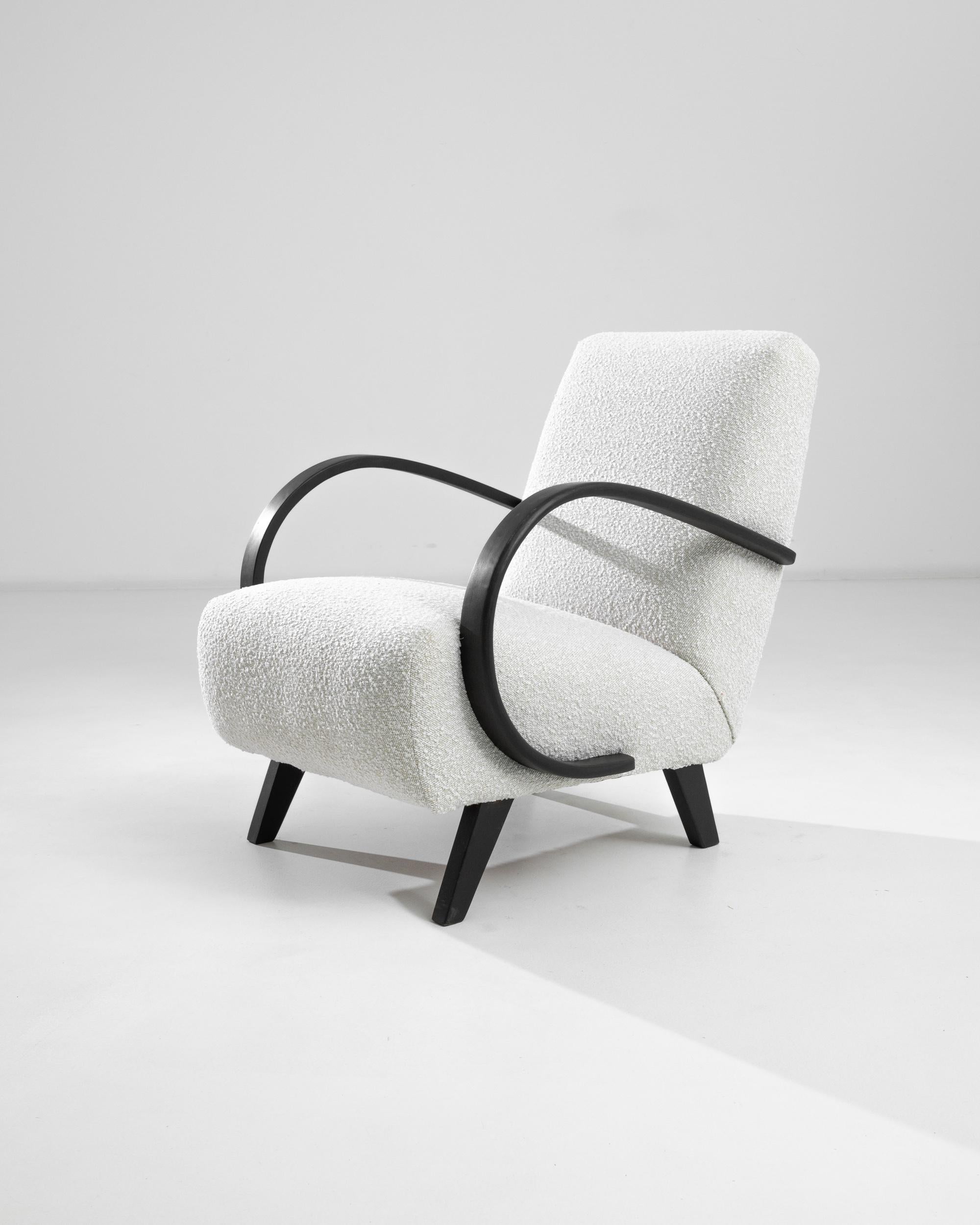Introducing the 1950s Czech Wooden Armchair by J. Halabala, a timeless piece that combines vintage charm with modern comfort. This exquisite armchair features elegantly curved wooden armrests that provide a striking contrast to its plush, textured