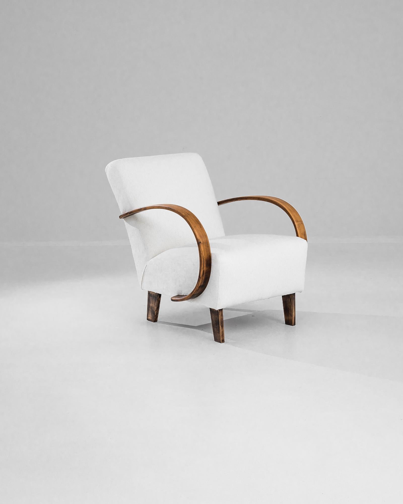 Discover the timeless elegance of this 1950s Czech Wooden Armchair, a masterpiece crafted by the renowned designer J. Halabala. This exquisite piece showcases a perfect blend of mid-century modern aesthetics and superior craftsmanship. The