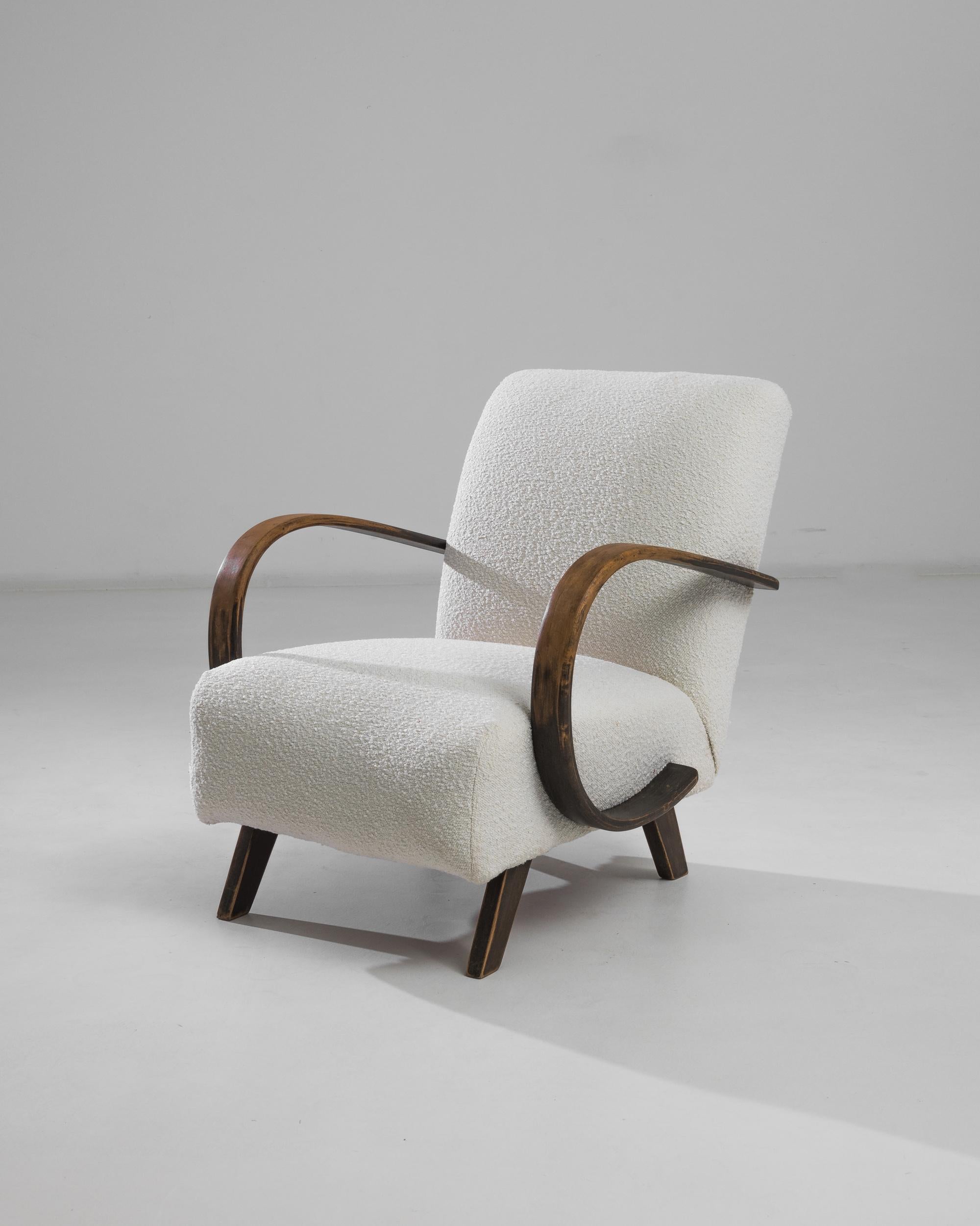 Discover the timeless elegance of this 1950s Czech Wooden Armchair, a masterpiece crafted by the renowned designer J. Halabala. This exquisite piece showcases a perfect blend of mid-century modern aesthetics and superior craftsmanship. The