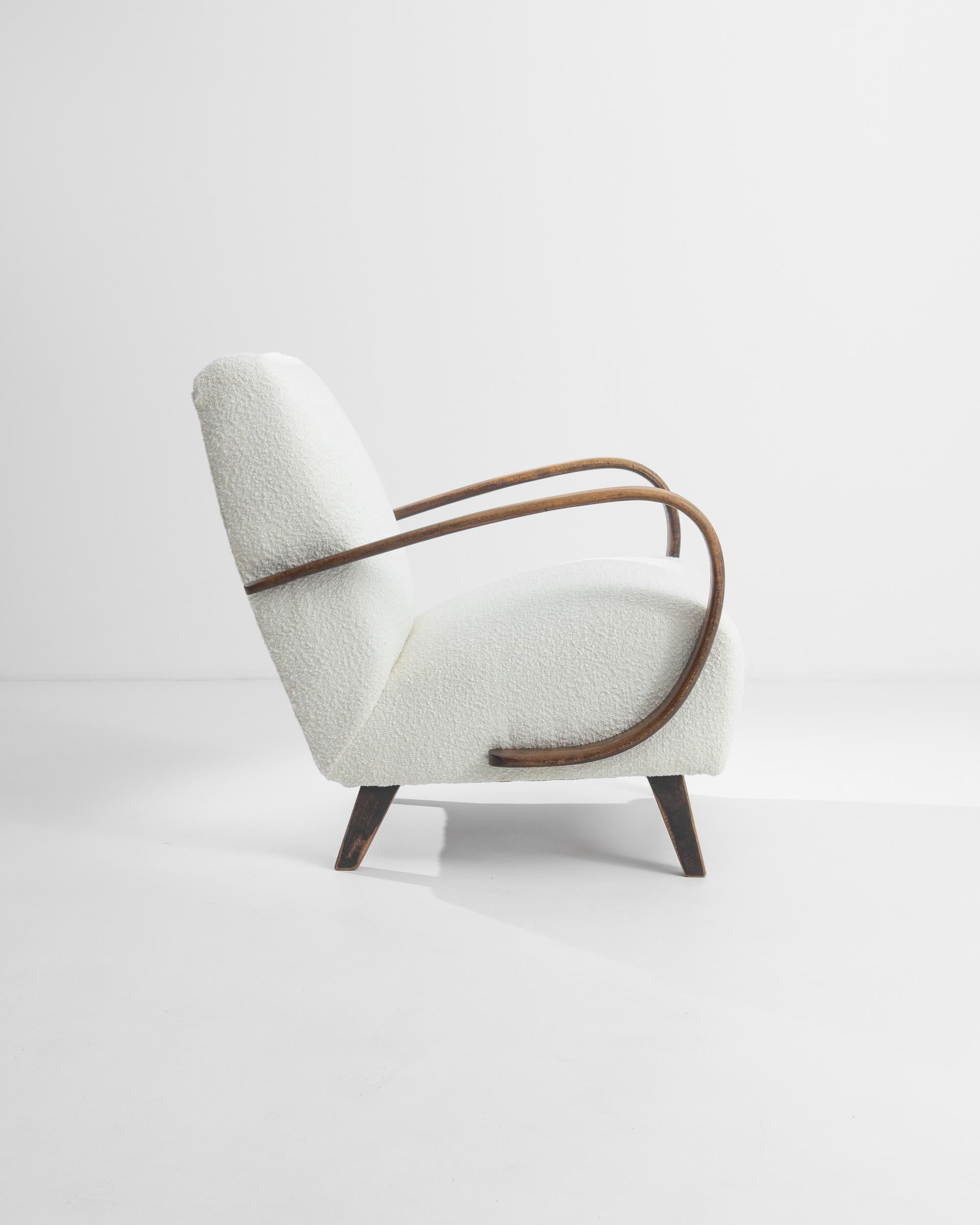 Discover the timeless elegance of this 1950s Czech Wooden Armchair, a masterpiece crafted by the renowned designer J. Halabala. This exquisite piece showcases a perfect blend of mid-century modern aesthetics and superior craftsmanship. The