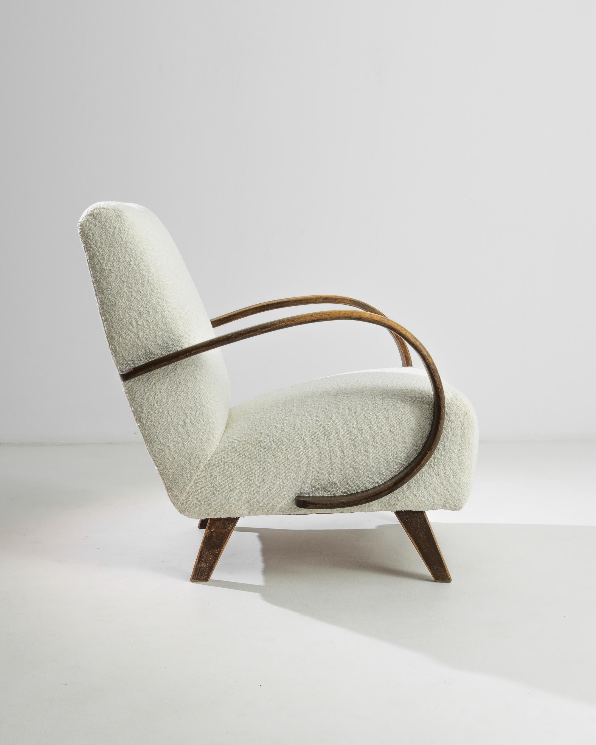 Embrace the charm and sophistication of the 1950s with this exquisite Czech Wooden Armchair by the legendary designer J. Halabala. A true icon of Art Deco design, this armchair features Halabala's signature sweeping wooden arms, gracefully curving