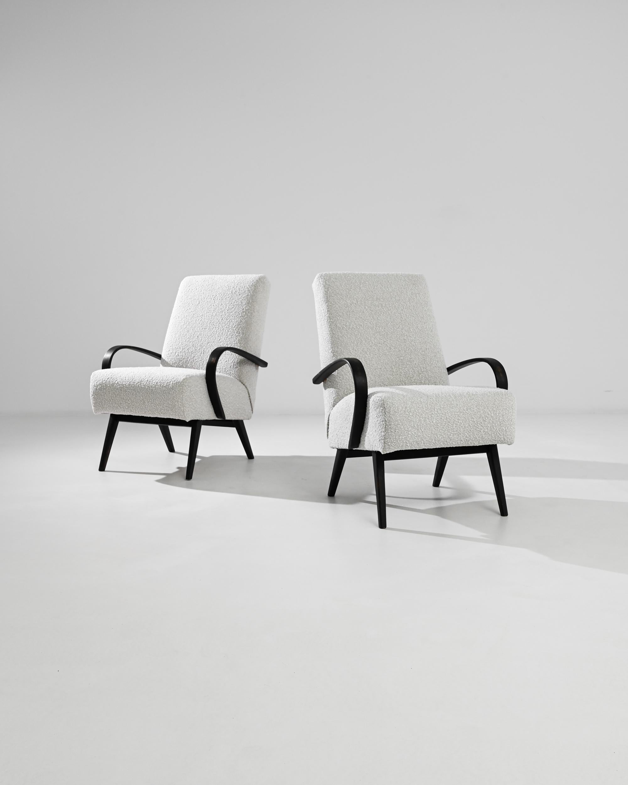 Enhance your interior with this exquisite pair of 1950s Czech Wooden Armchairs by the iconic designer Jindřich Halabala. Meticulously crafted, these armchairs are a quintessential representation of mid-century modern design, blending form and