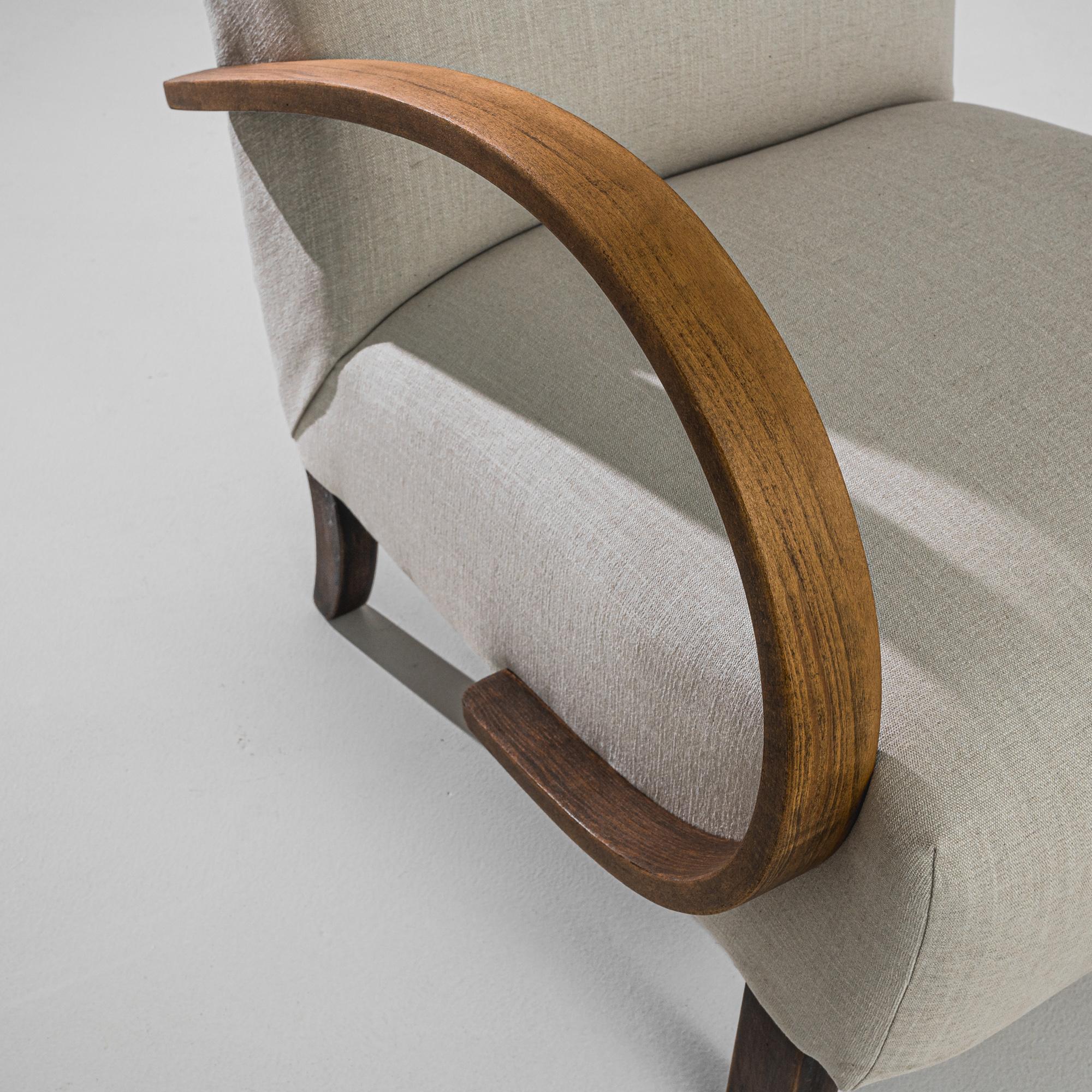 Step into the elegance of mid-century design with these 1950s Czech Wooden Armchairs by J. Halabala. Crafted with a striking combination of timeless aesthetics and ergonomic comfort, these chairs feature gracefully curved wooden armrests that offer