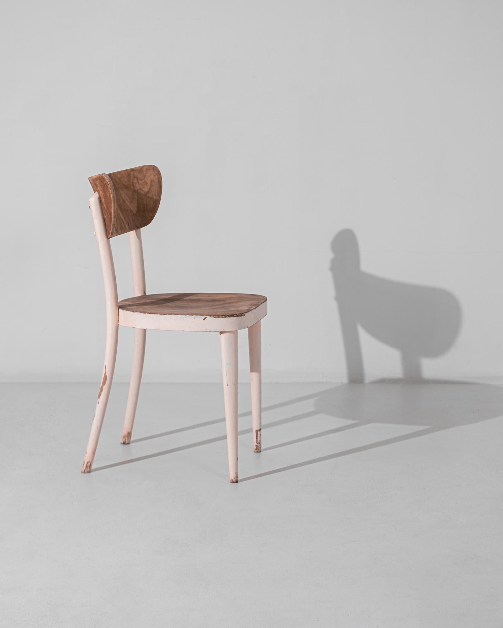 From the mid-century era of 1950s Czechia emerges this remarkable wooden chair, a testament to the ingenuity and craftsmanship of the time. Crafted with precision and care, this chair embodies the simplicity and functionality synonymous with